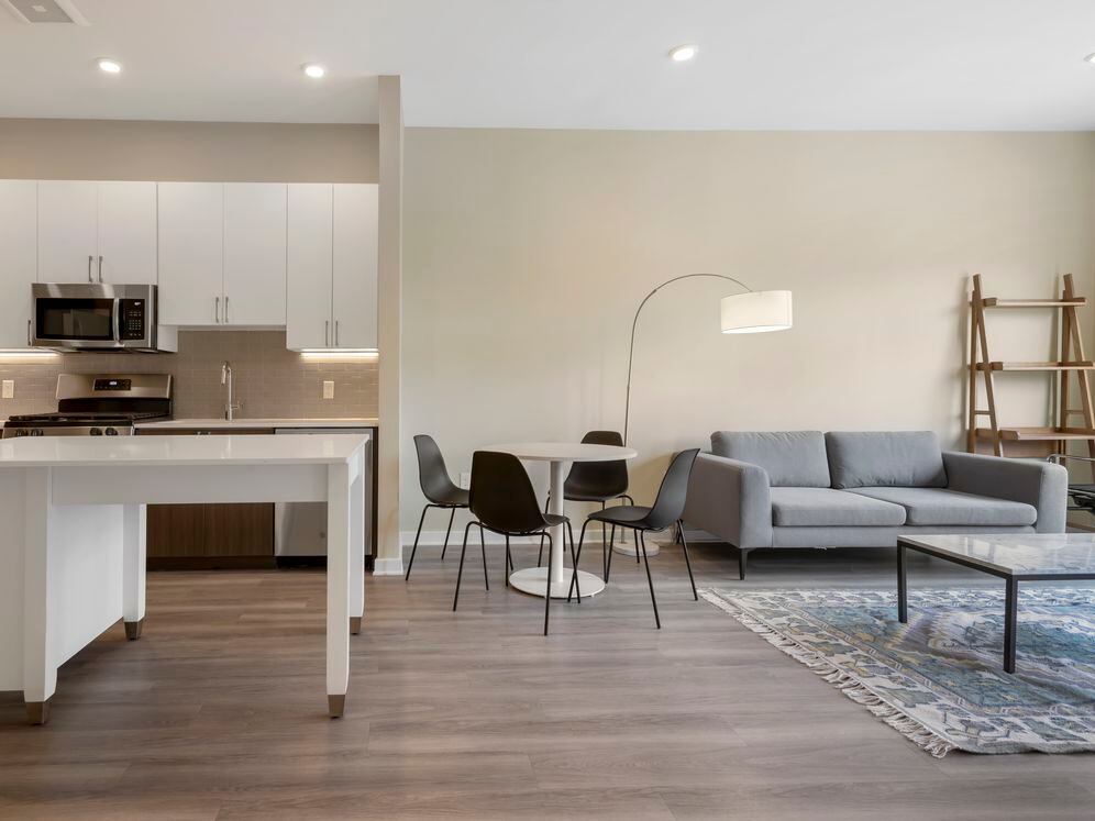 Furnished+ apartment homes include a dining set (Representative Image – exact items and style of furnishings may vary)