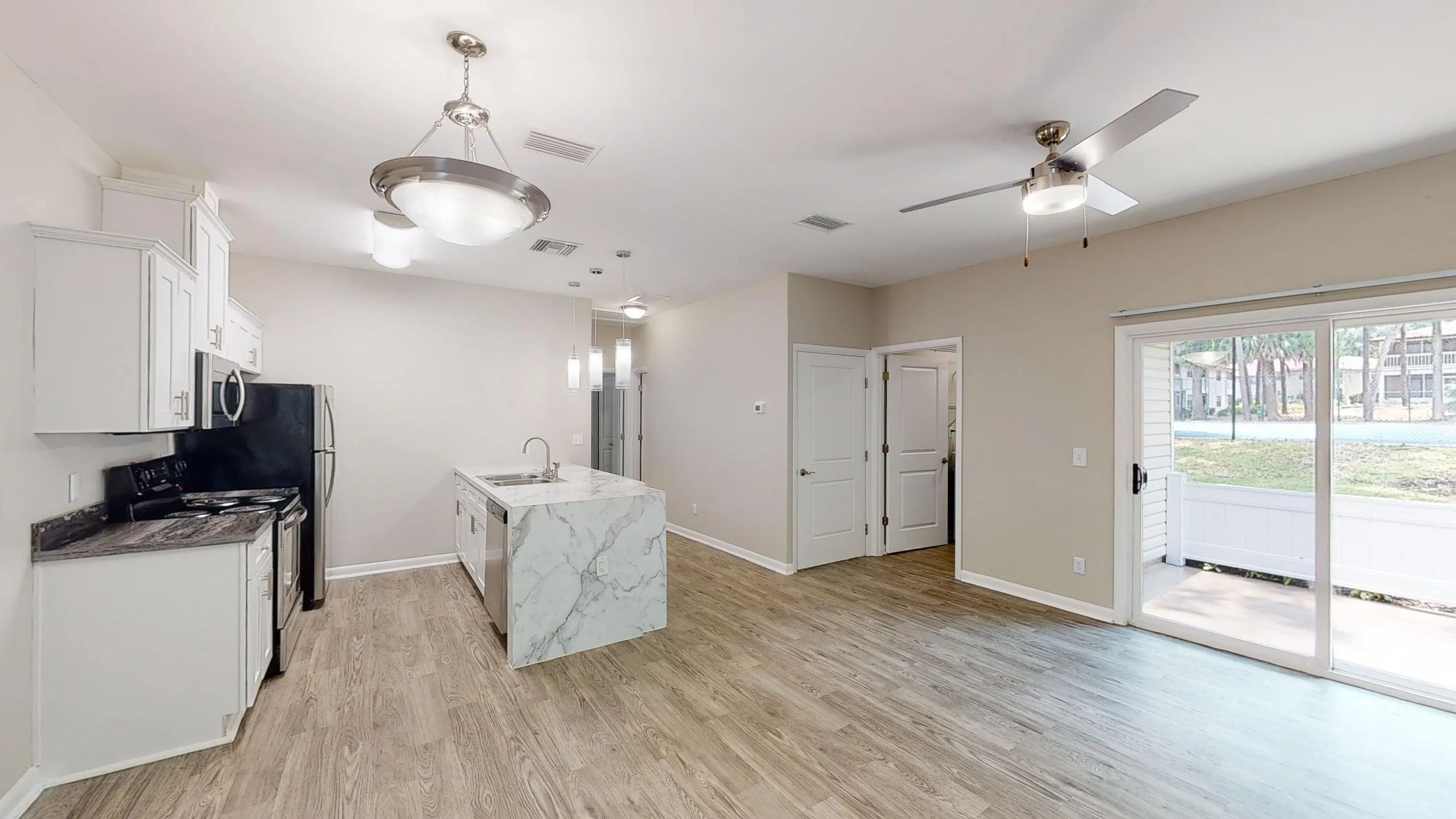 The Rosewood offers a bright, open layout that brings together the kitchen, dining, and living areas featuring wood-style flooring and access to a private patio.