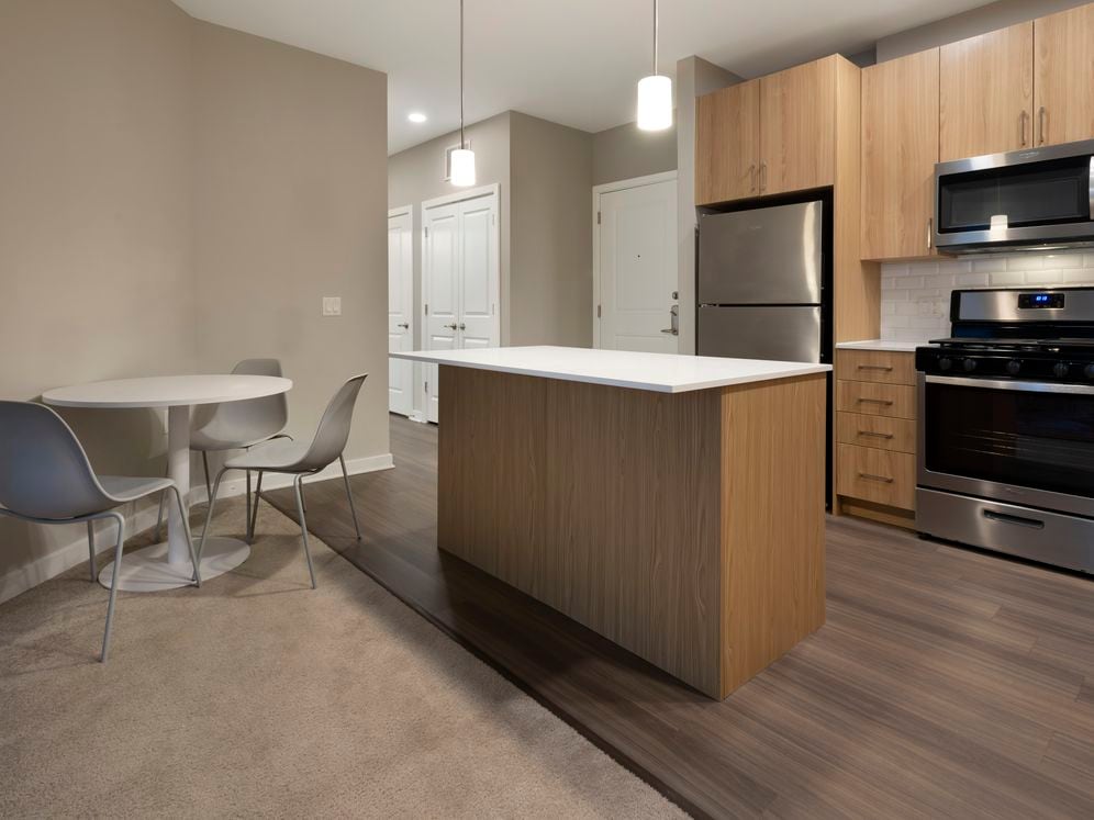 Furnished+ apartment homes include a dining set (Representative Image – exact items and style of furnishings may vary)