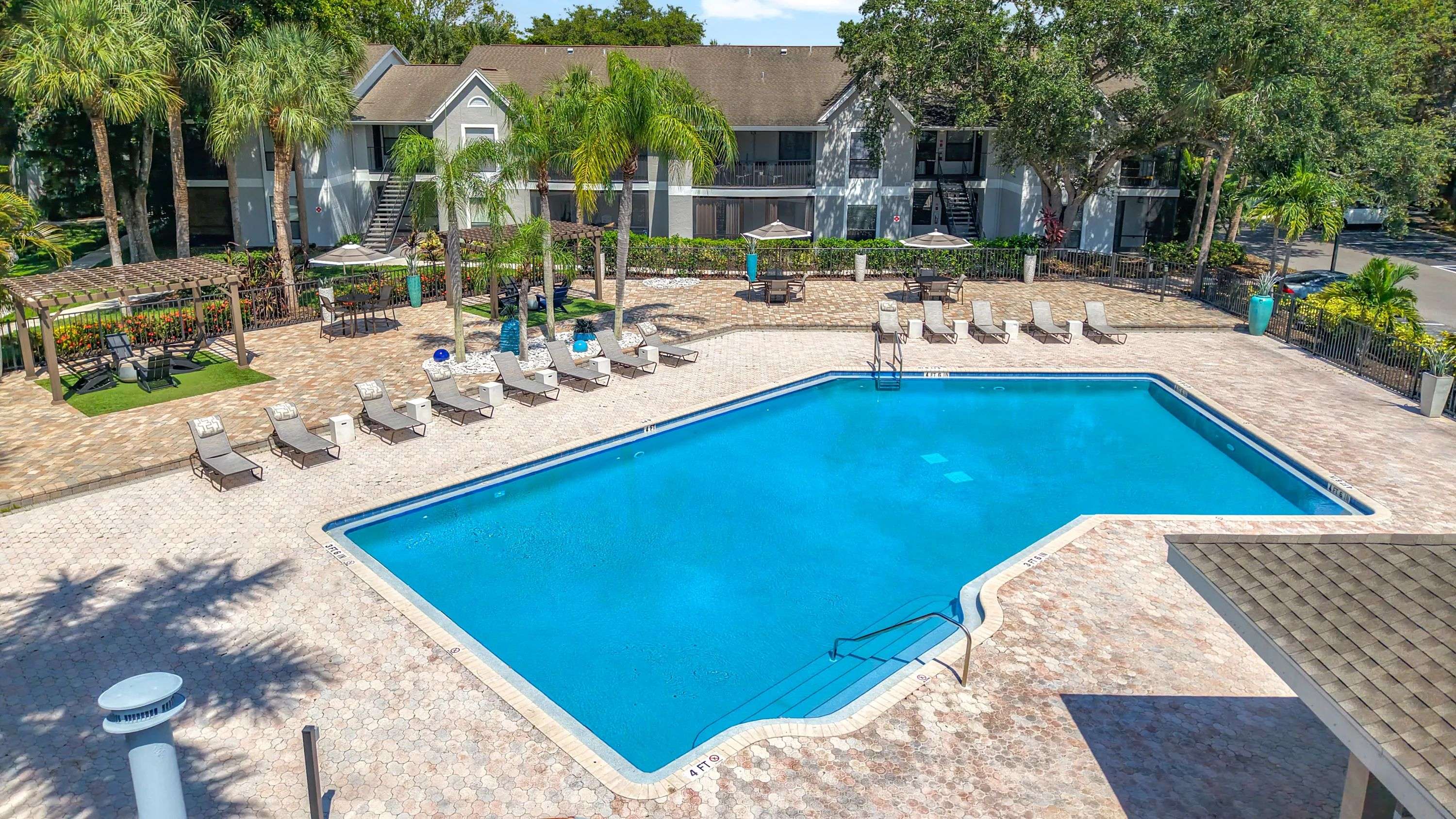 Unwind in style at River Reach’s expansive resort-style pool deck, complete with lounge chairs, pergolas, and lush palm trees for that true Florida feel.