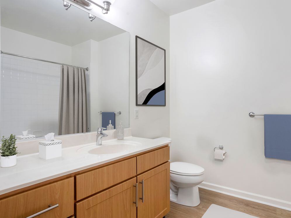 Classic Package bath with oak cabinetry, white quartz countertops, and hard surface flooring