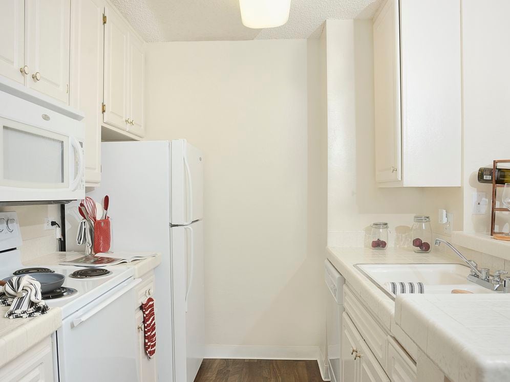 Classic Package I kitchen with white appliances, white tile countertops, white appliances, and vinyl tile flooring