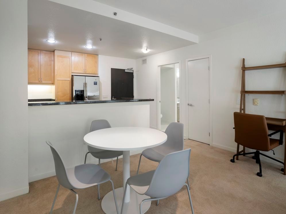 Furnished+ apartment homes include a dining set (Representative Image – exact items and style of furnishings may vary)