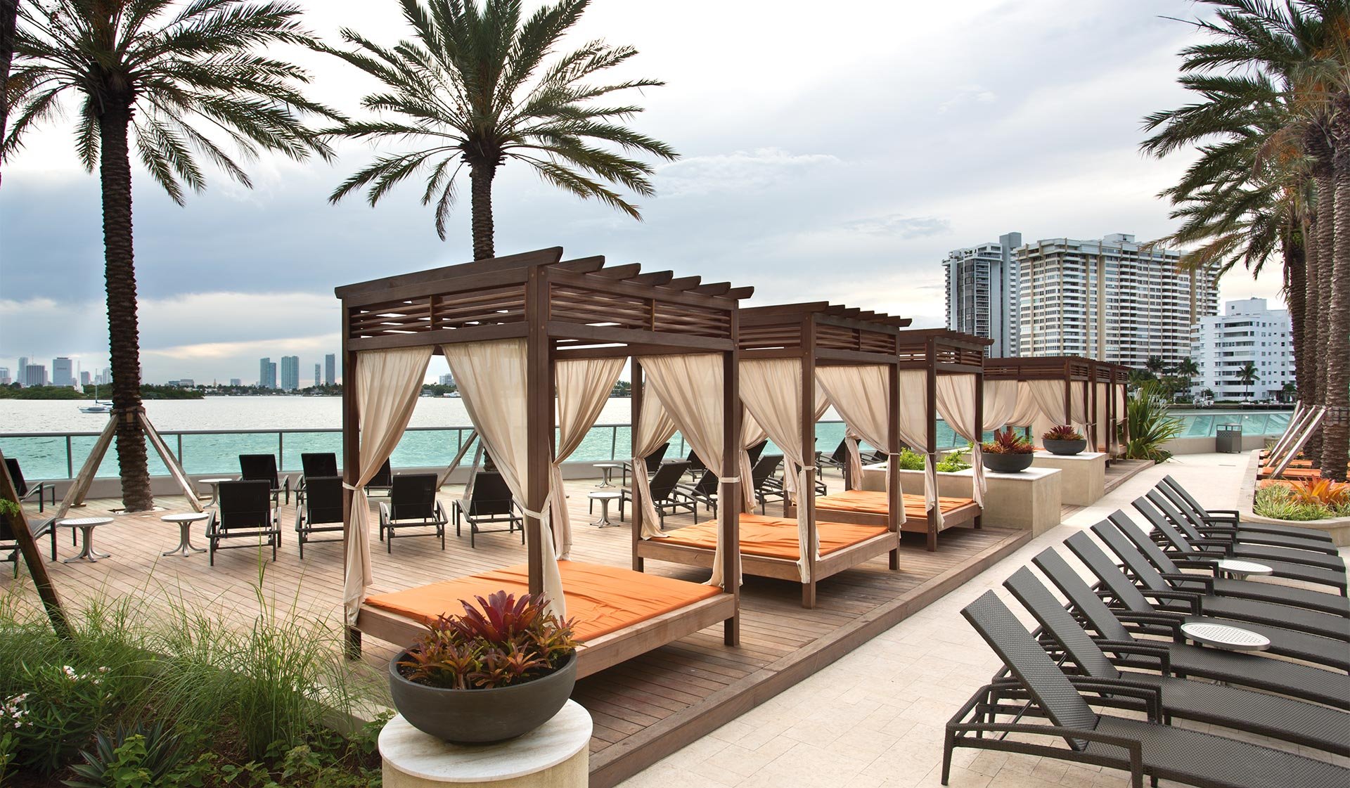 Resort-style pool area with private cabanas