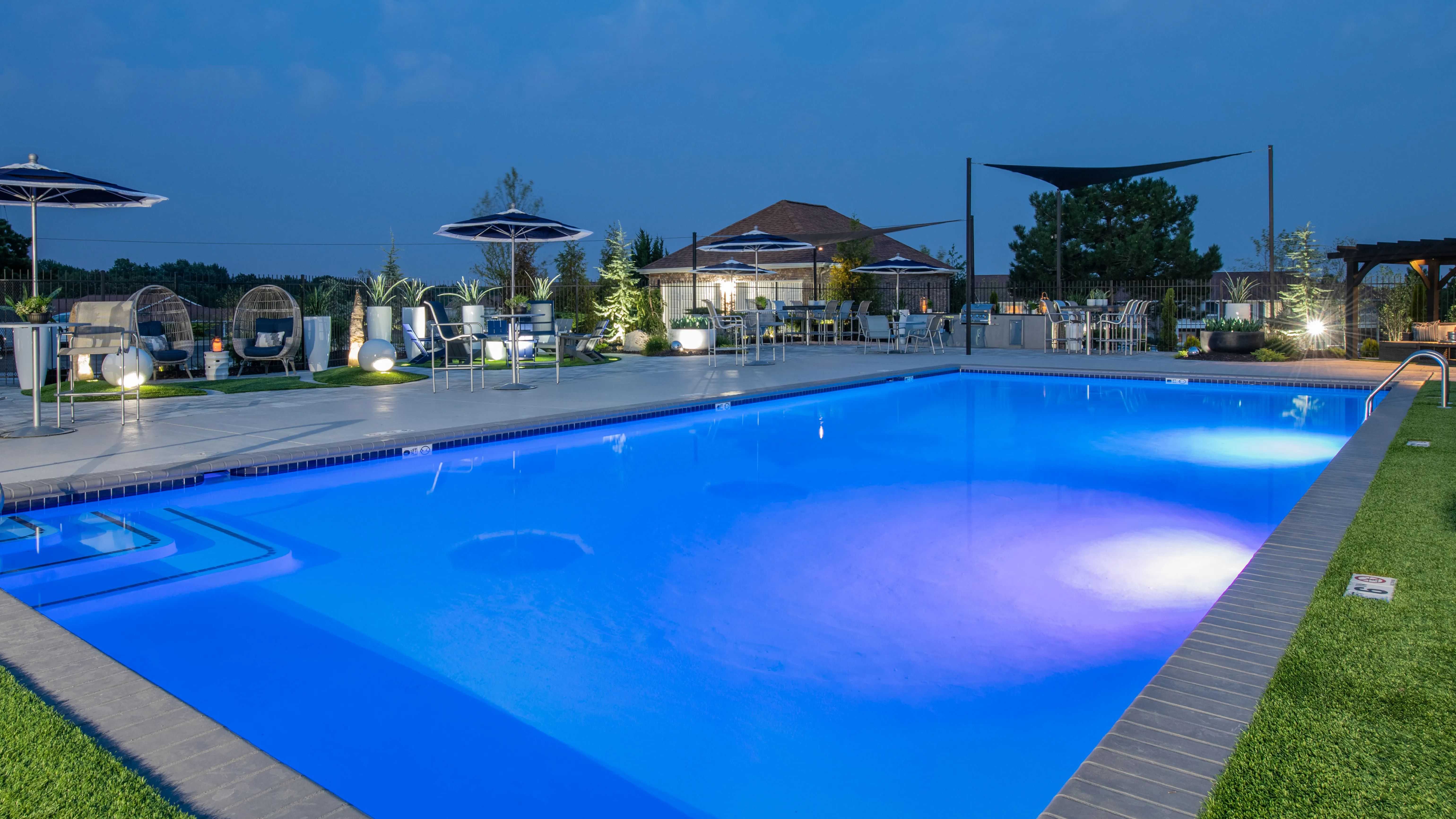 Revel in the captivating allure of the pool at night, where residents can enjoy an elegant and revitalizing ambiance under the stars.