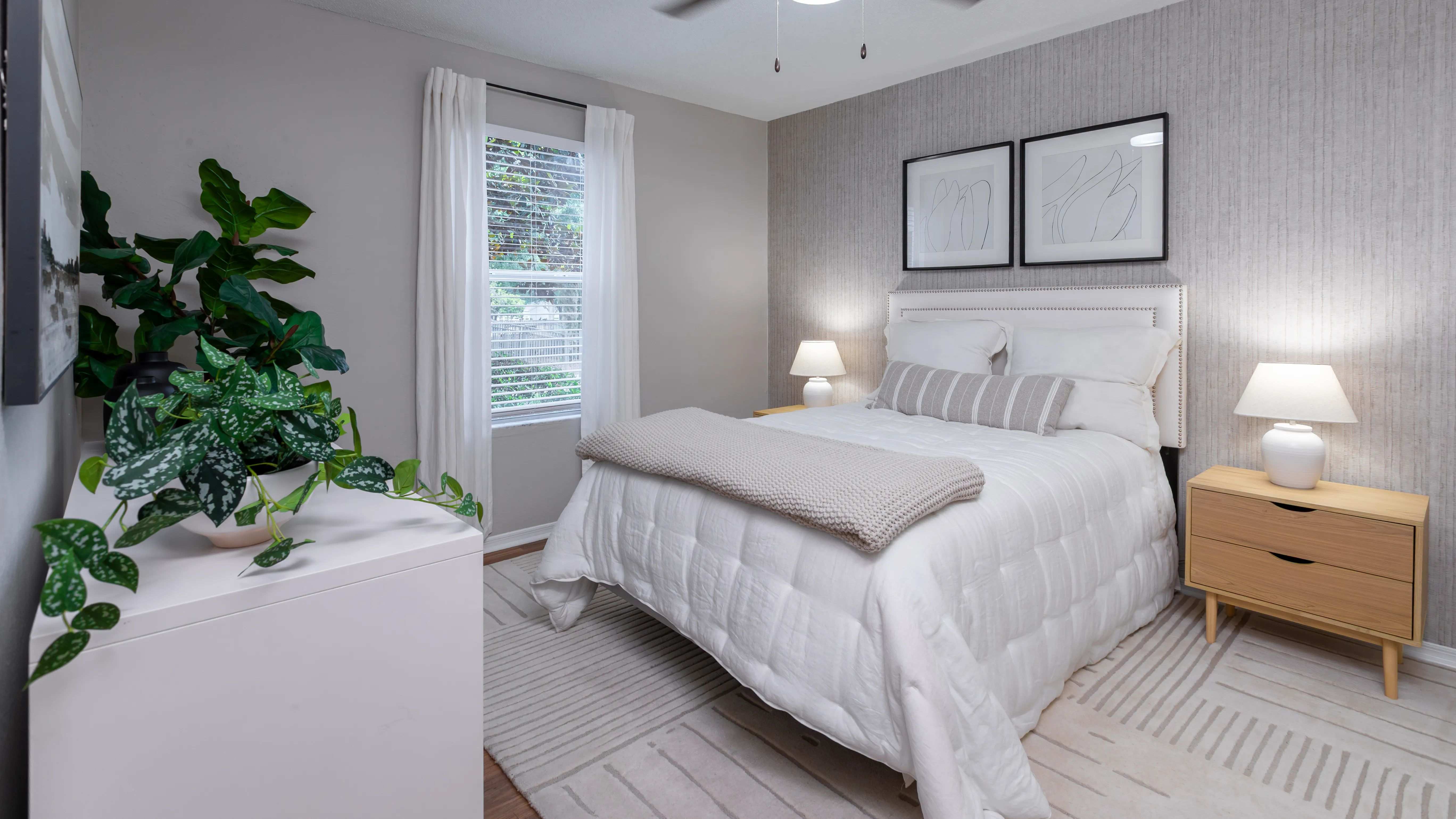 Master bedroom featuring wood-style flooring, spacious closet, and large window.