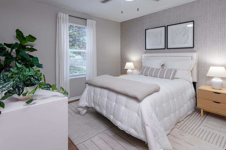 Master bedroom featuring wood-style flooring, spacious closet, and large window.