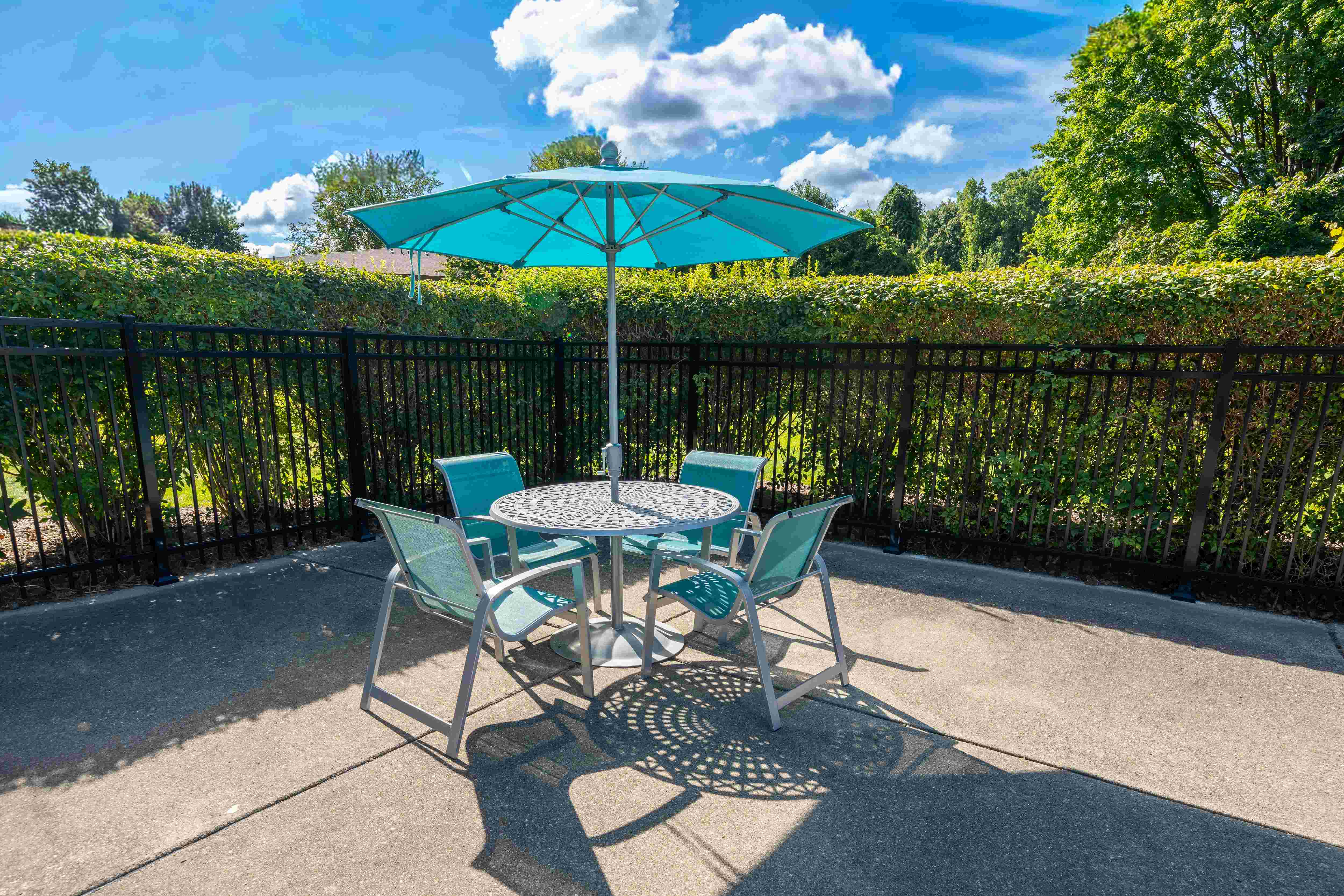 Umbrella and Chairs on Sundeck at Westwood Village Apartments in Westland