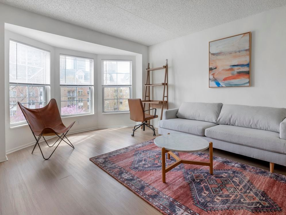 Furnished+ apartment homes come outfitted with a sofa, side chair, side table, coffee table, office chair, desk, TV stand and 50" Television (Representative Image – exact items and style of furnishings may vary)