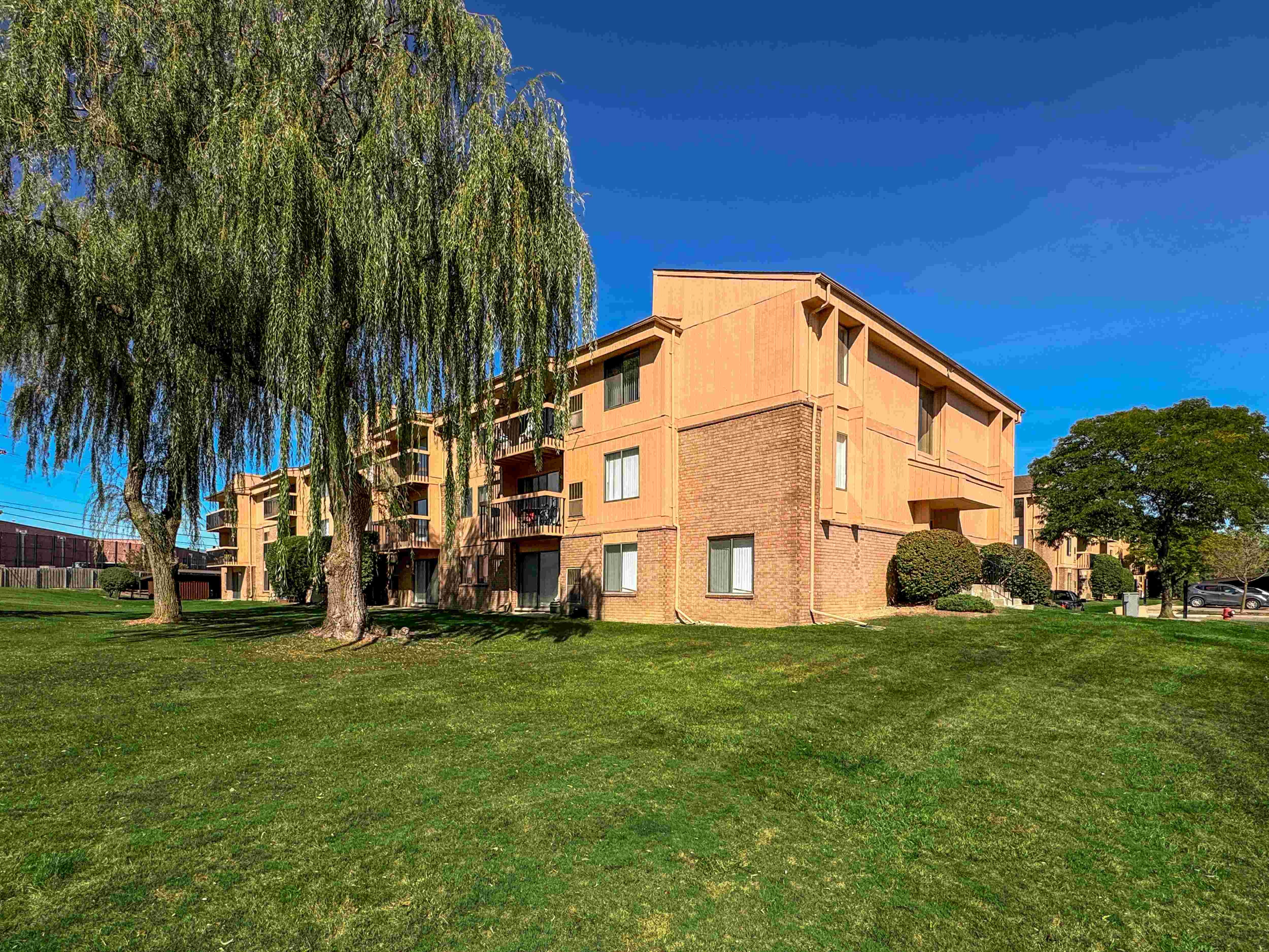 Expansive Green Space Apartment Building Exterior at Franklin River Apartments, Southfield, MI