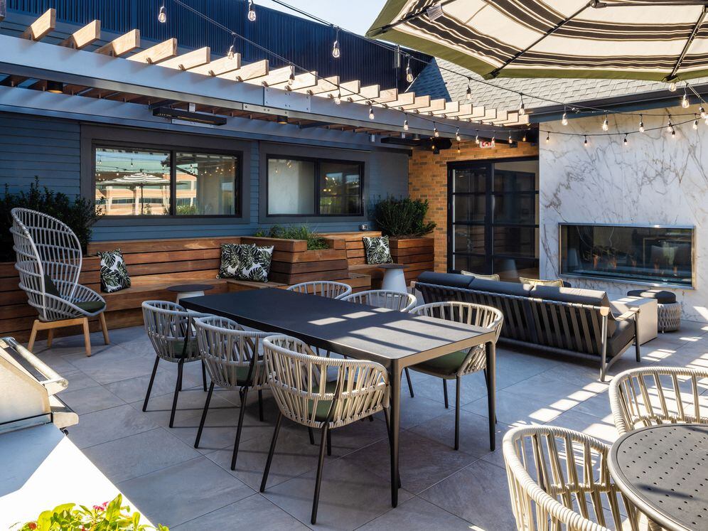 North Building Roof deck with lounge seating, fireplace, and grills