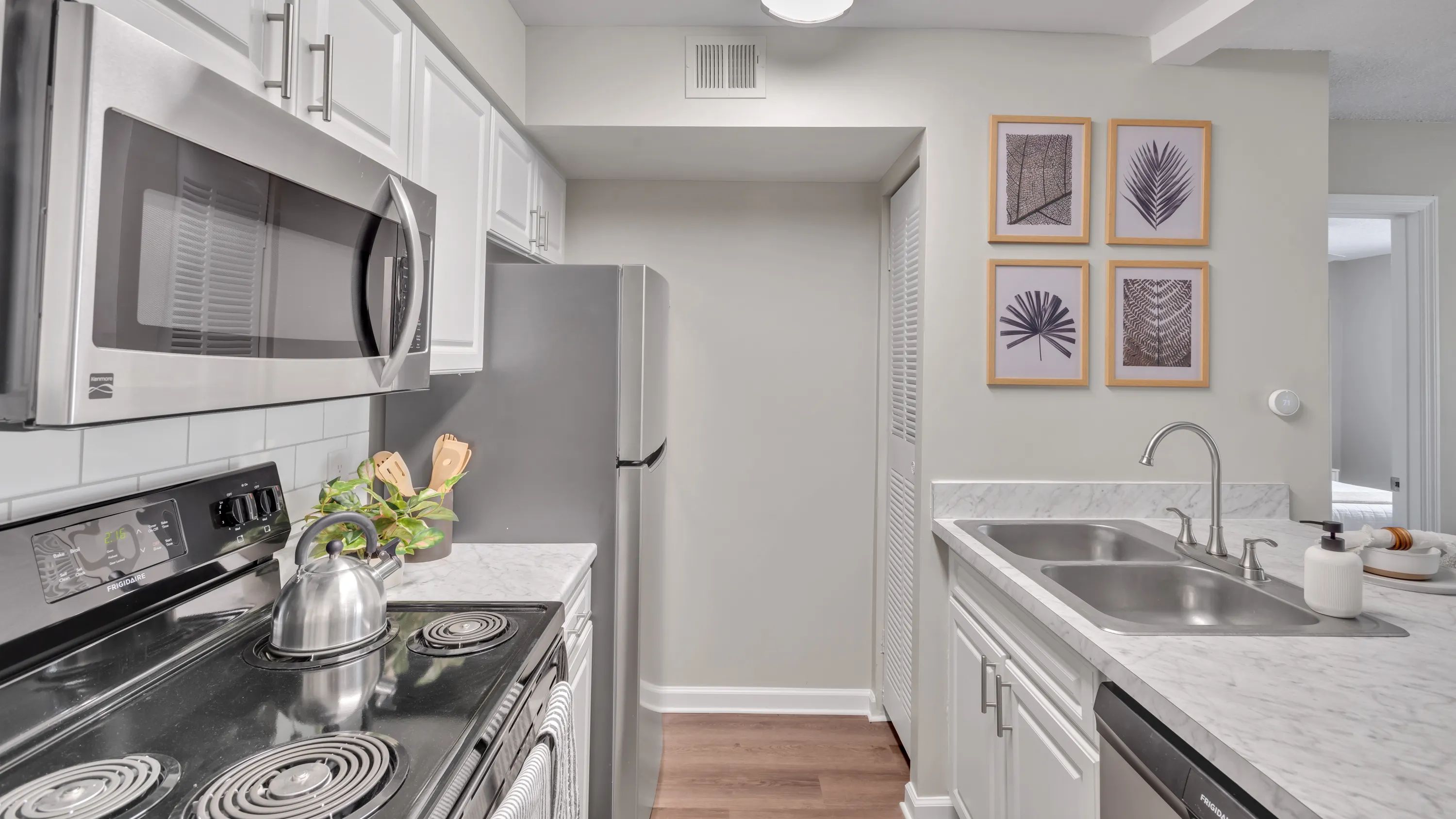 Our floor plans showcase galley-style kitchens with modern, pristine white cabinetry and stainless-steel appliances, creating a kitchen of grace and practicality. 