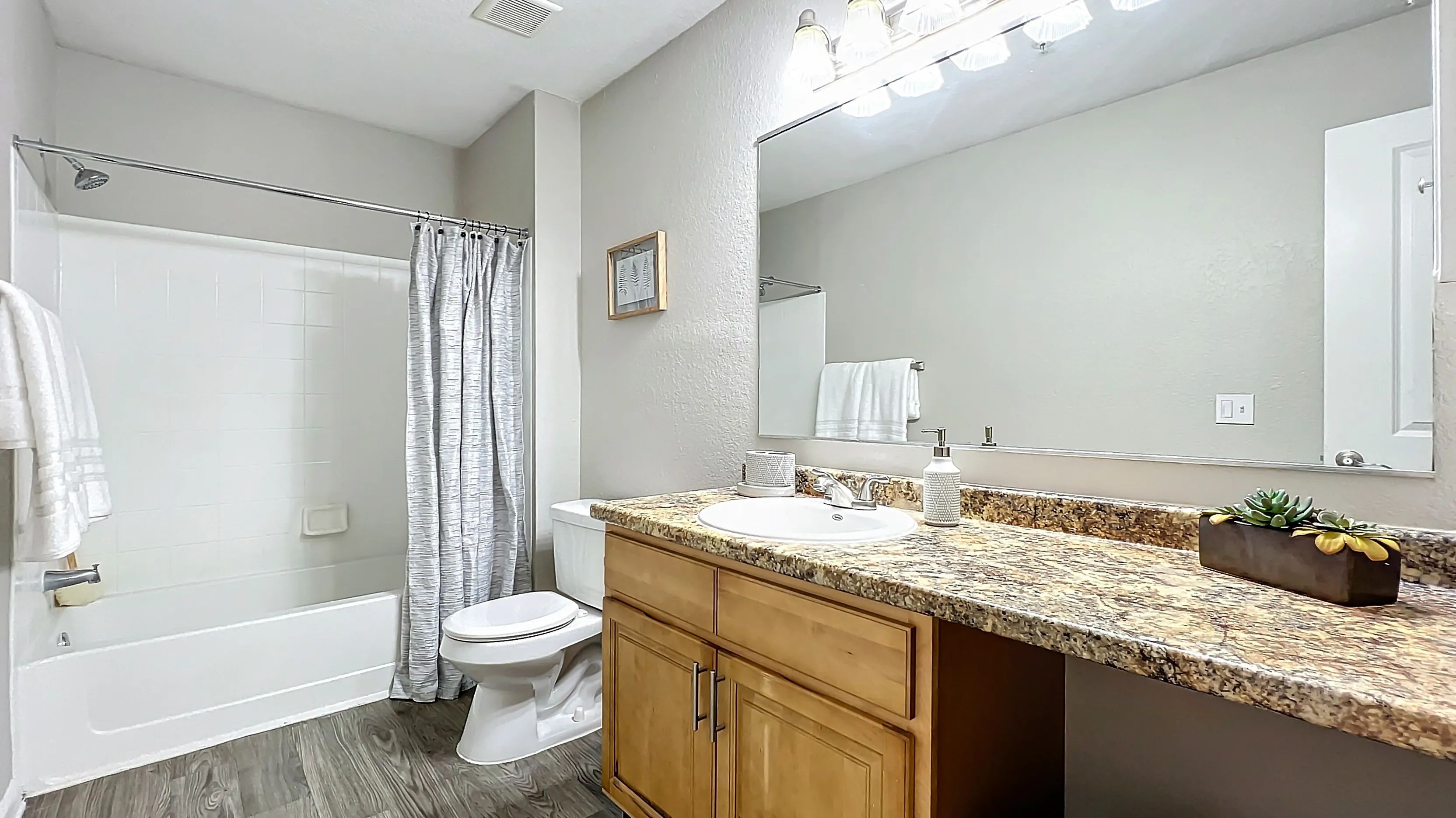 Enjoy the elegance and functionality of our modern bathrooms, featuring granite-style countertops, ample storage, and a sleek design.
