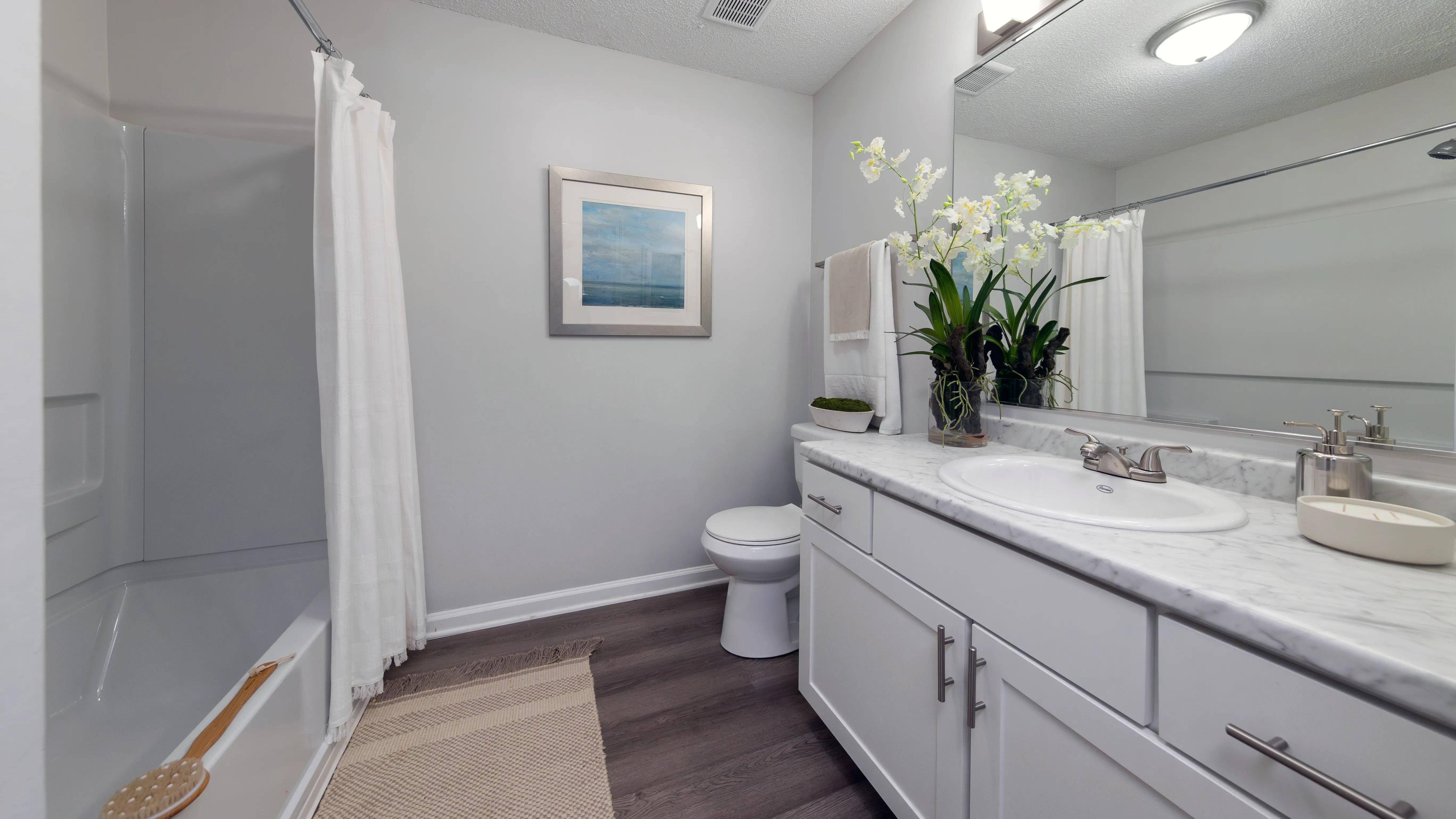 Enjoy natural lighting while you get ready in our spa-like bathroom with window and stylish features throughout 