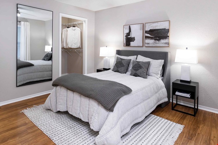 Spacious bedrooms featuring wood-style flooring and a spacious walk-in closet.