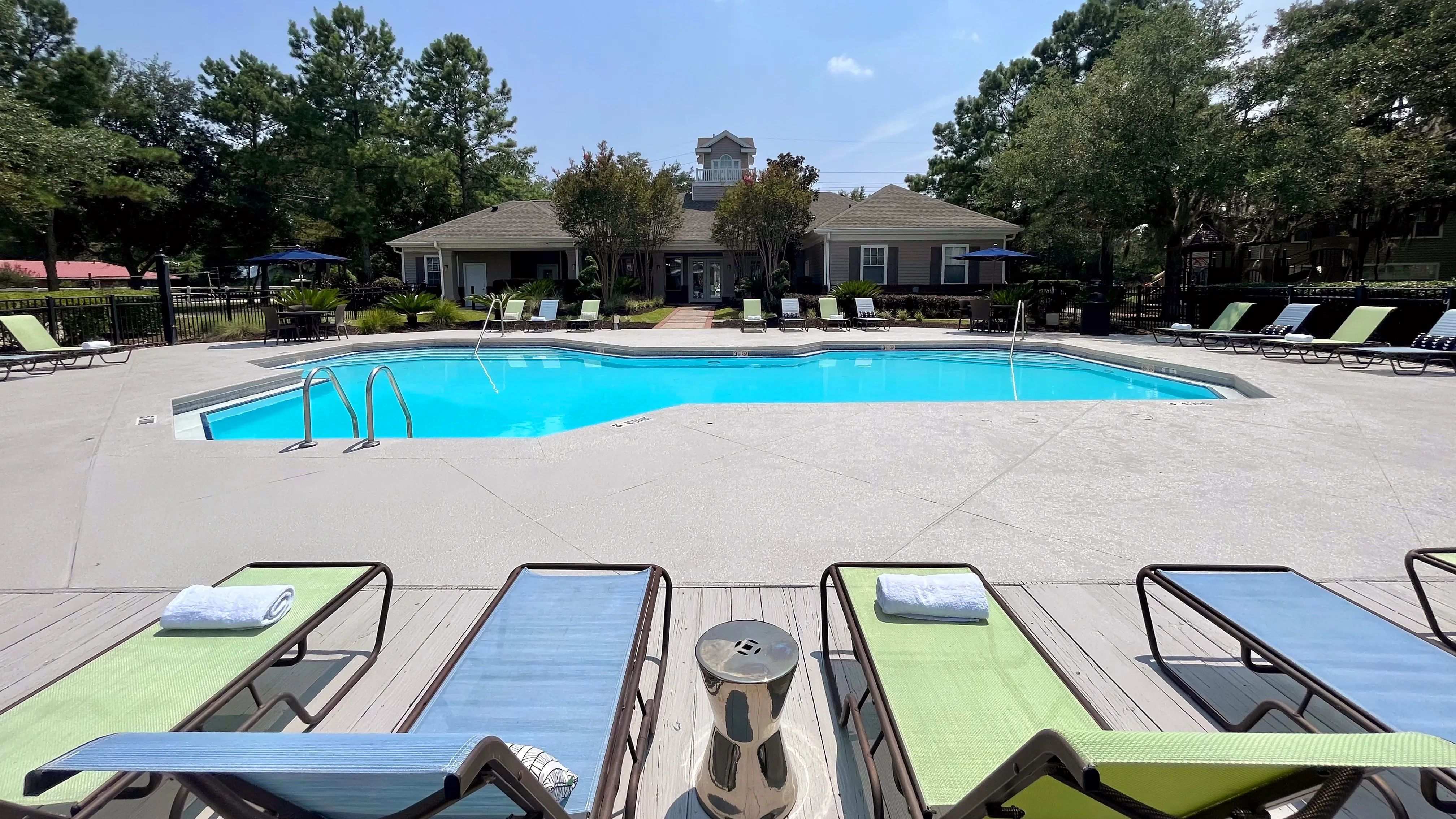 Dive into relaxation at the sparkling resort-style pool at Eagles Pointe Apartments. Surrounded by lush greenery and comfortable lounge chairs, it's the perfect spot to unwind or socialize.