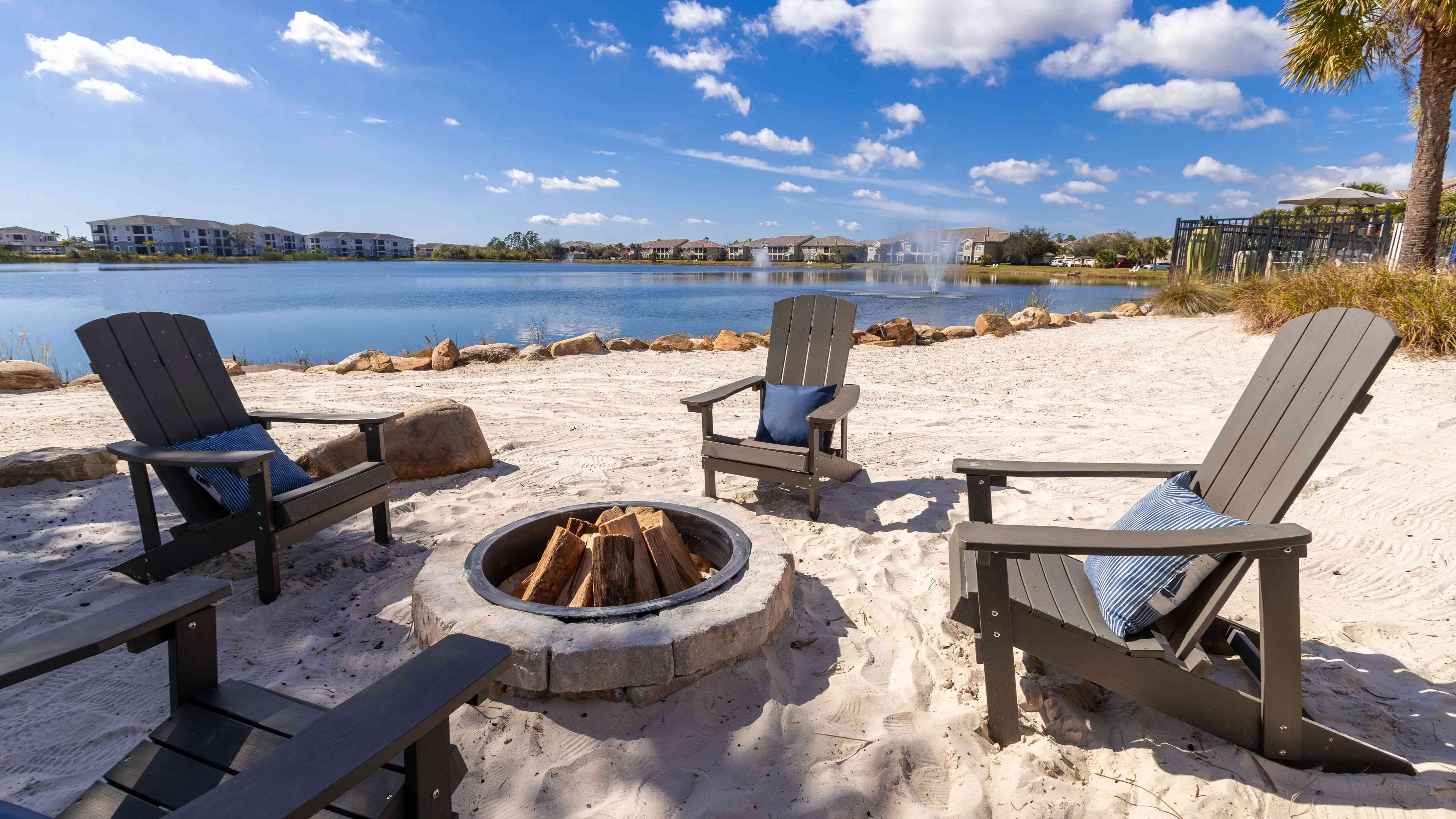 Enjoy cozy evenings by the fire with Adirondack seating and breathtaking lake scenery.