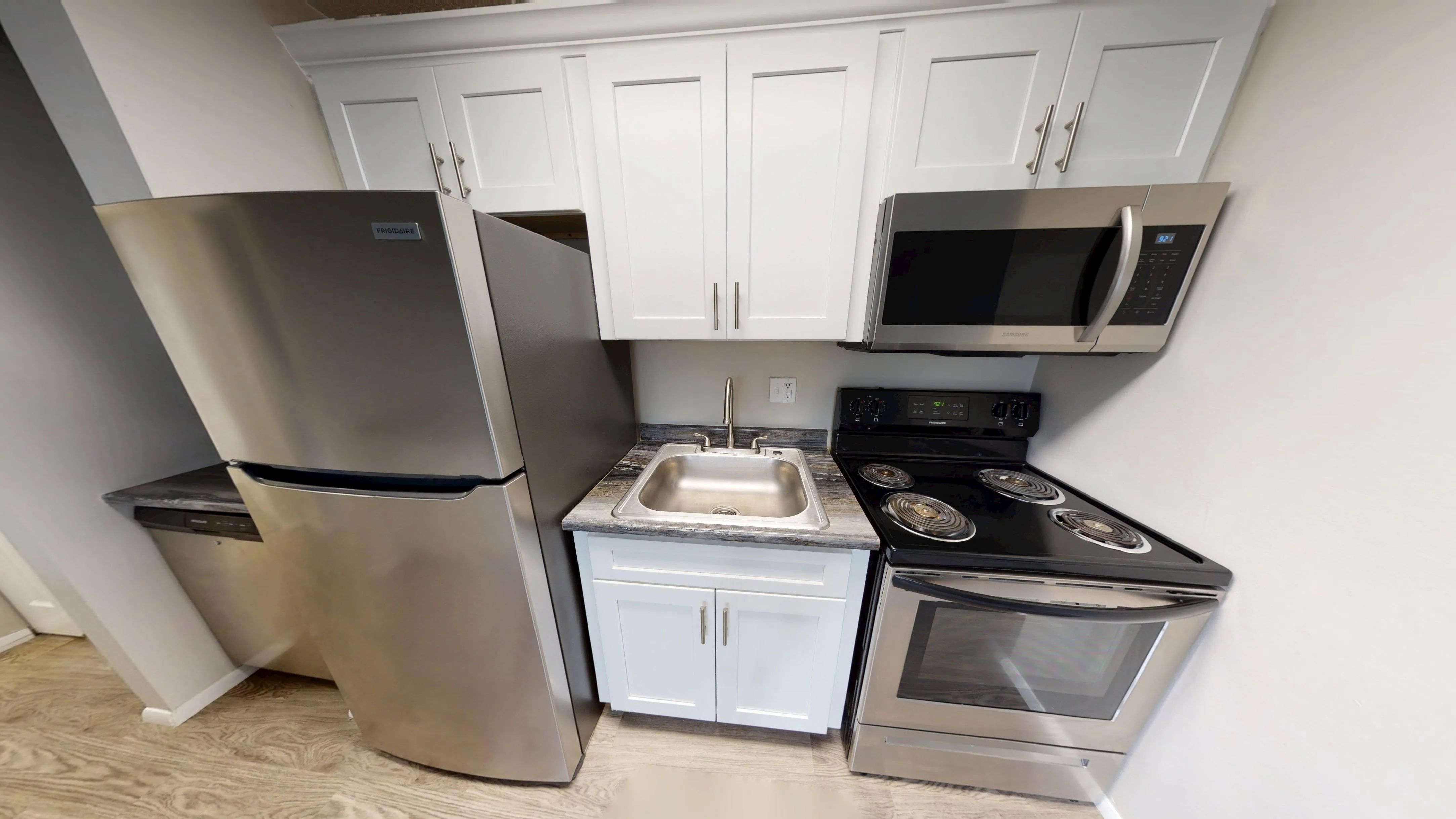 Enjoy a fully equipped kitchen with stainless steel appliances, modern cabinetry, and sleek countertops in The Dickenson floor plan at Aspen Chase Apartments.