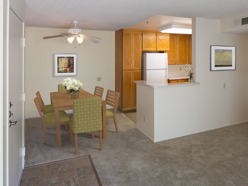 Classic Package kitchen with oak cabinetry, beige speckled laminate countertops, tile flooring, and white appliances