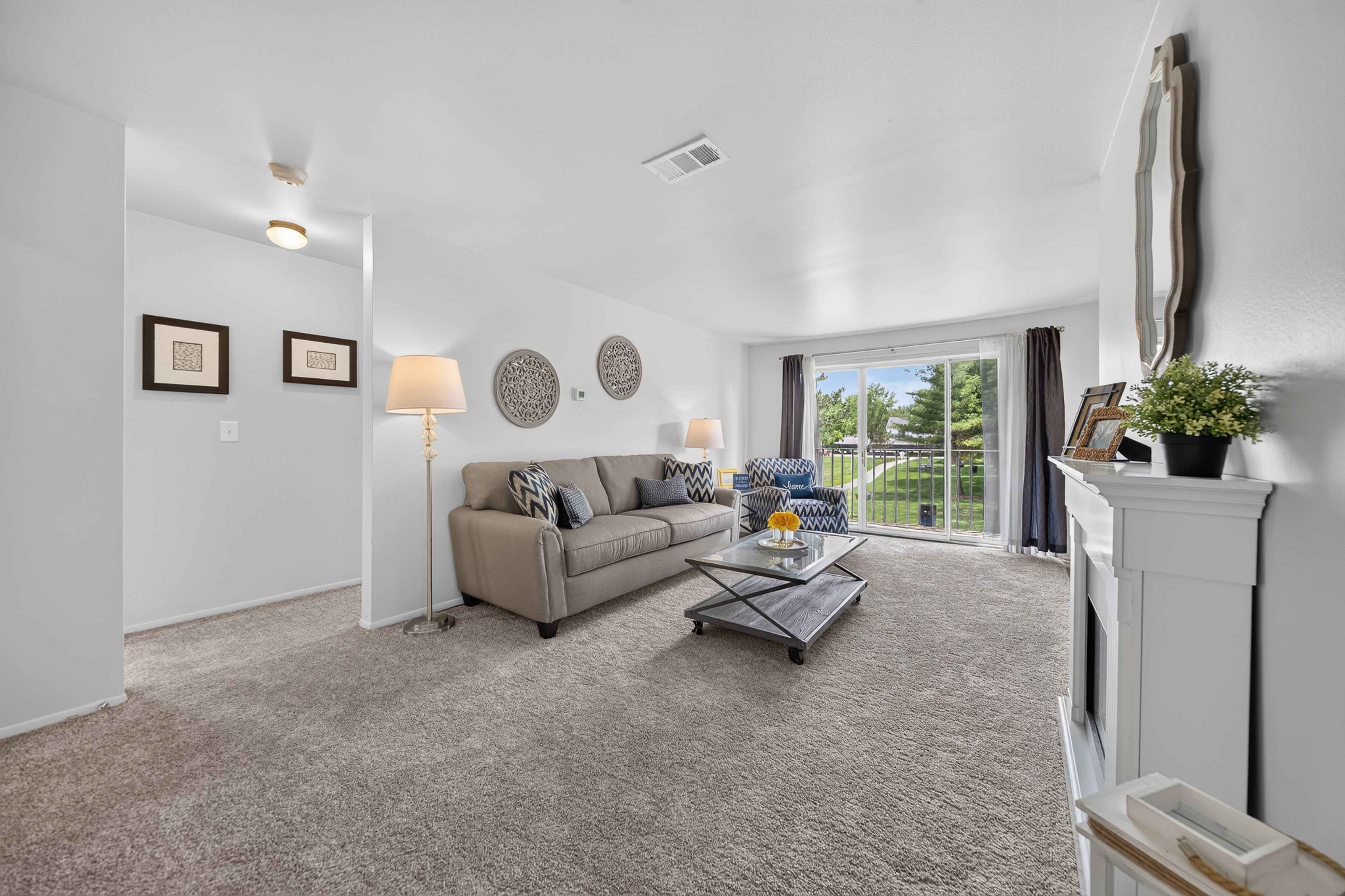 Elevated living room and private balcony at Drawbridge Apartments.