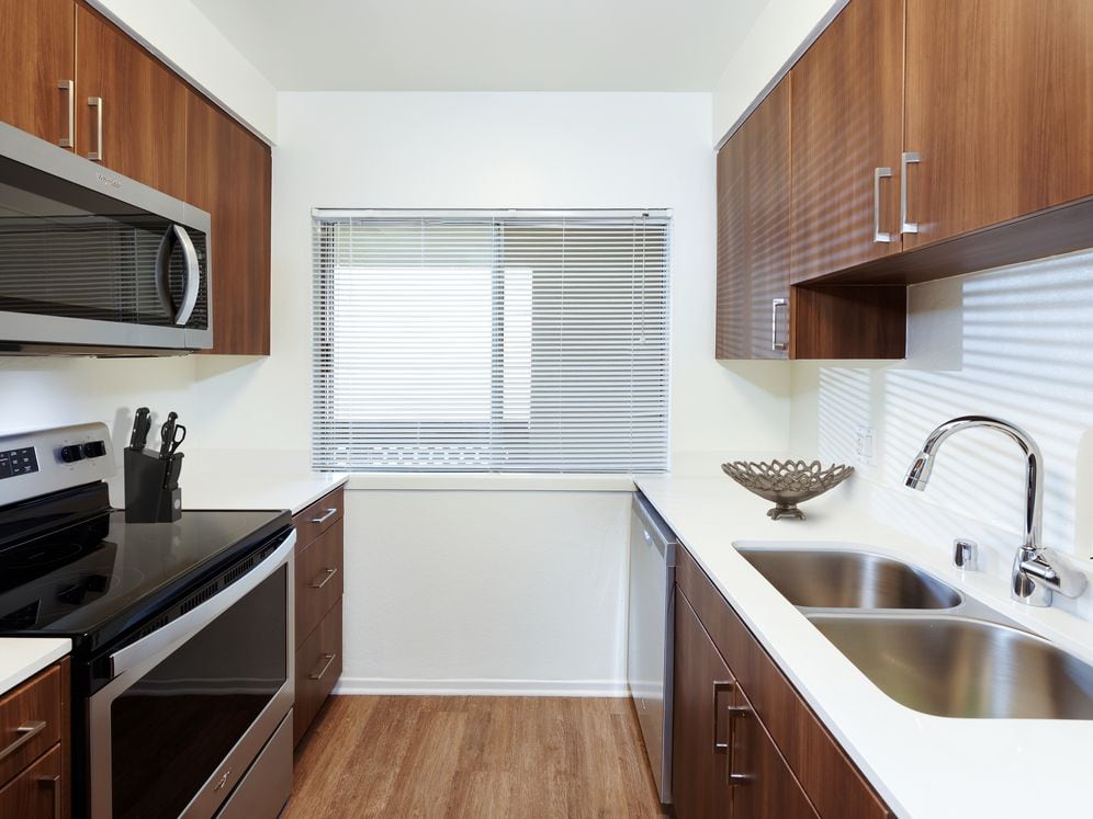 Renovated I kitchen with new cabinetry, quartz countertops, stainless steel appliances, and hard surface flooring