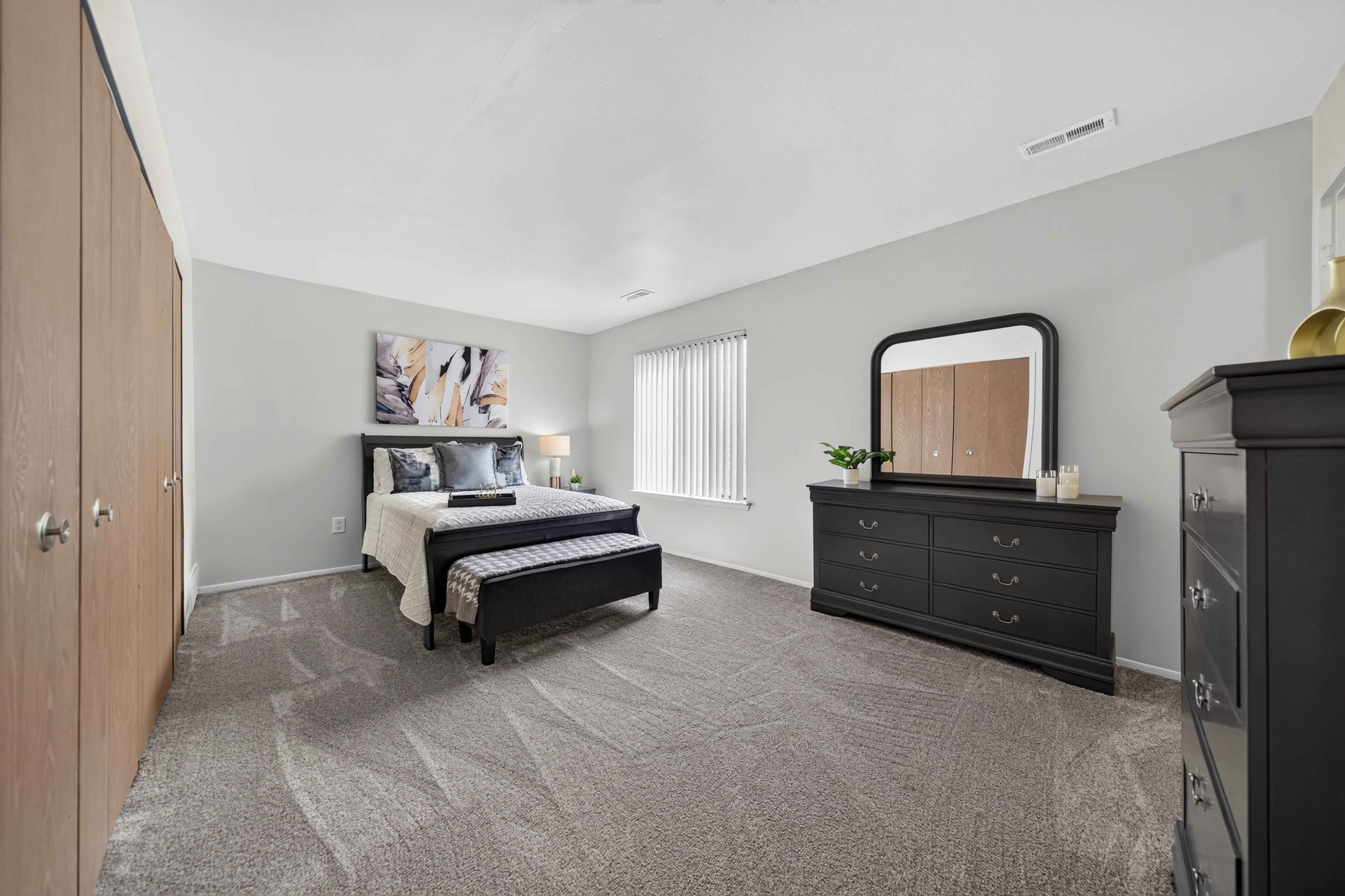 Spacious bedroom with ample storage at Franklin River Apartments in Southfield, MI.