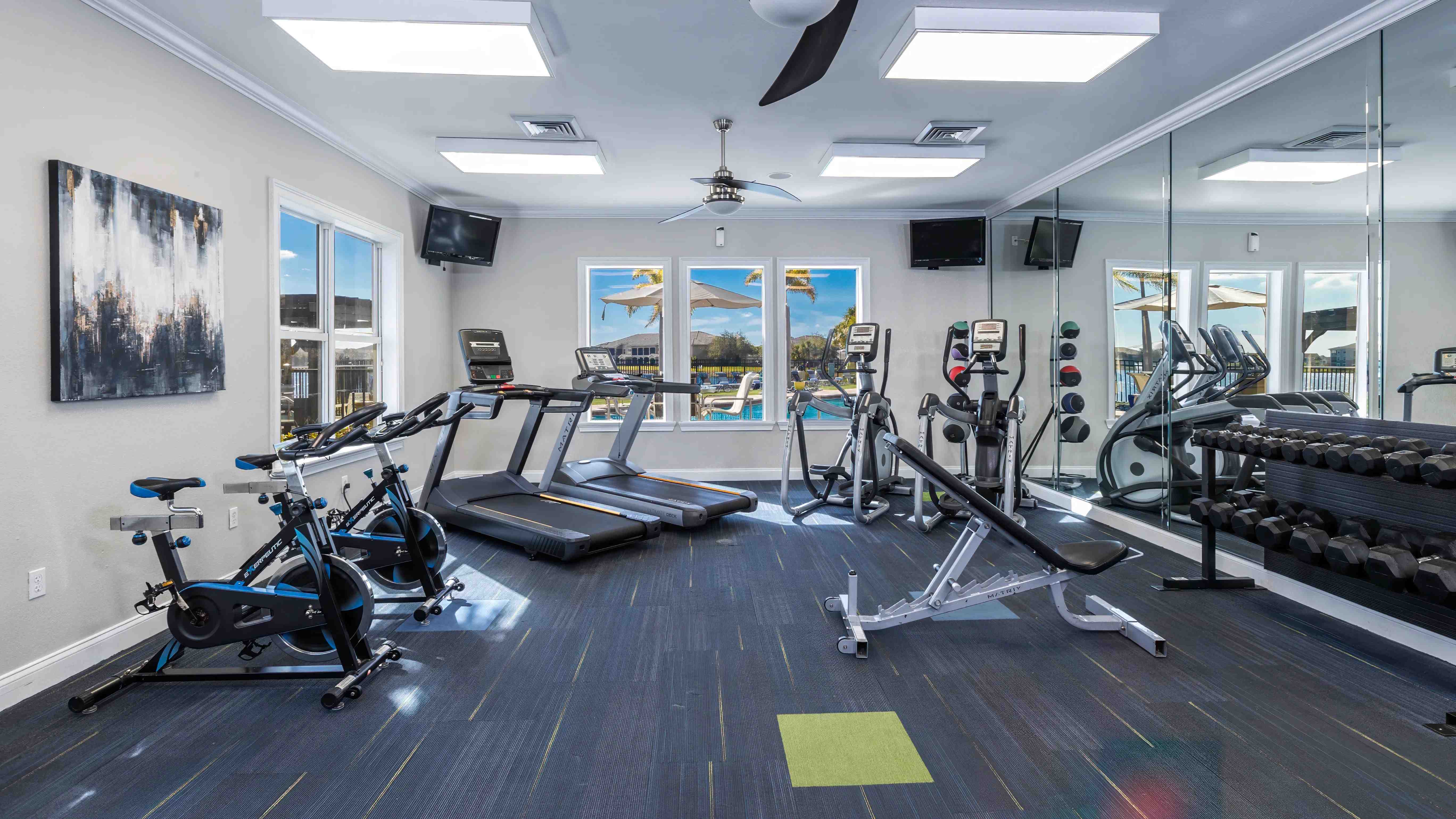Stay active in our fully equipped fitness center, featuring cardio machines, free weights, and pool views.