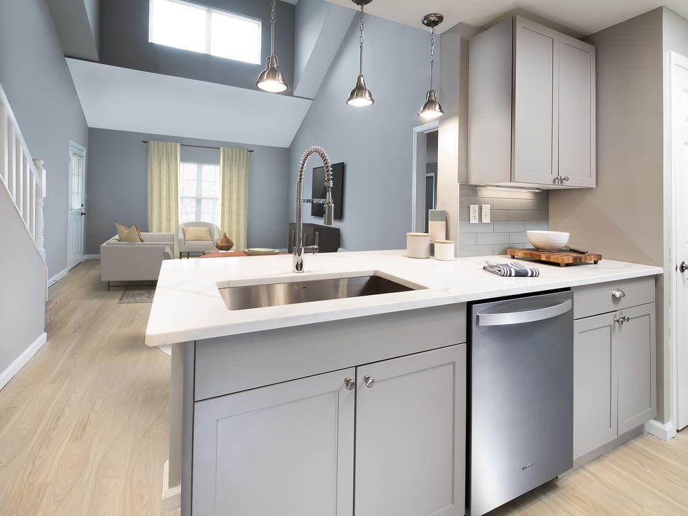 Premier Finish kitchen, dining, and living areas with hard surface flooring