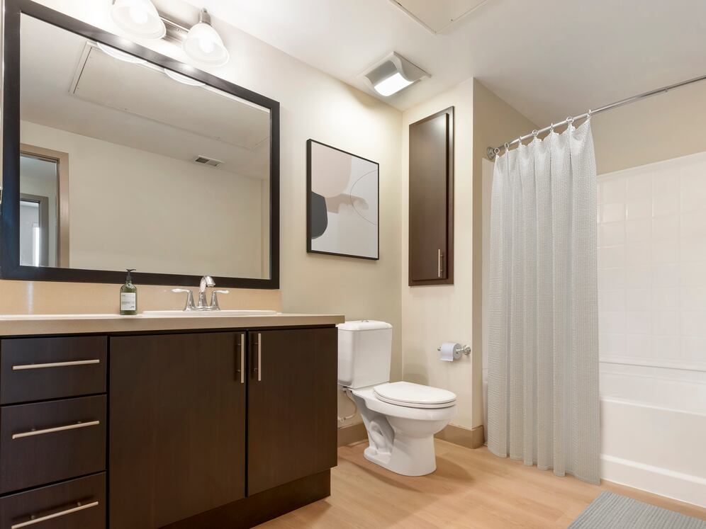 Classic Collection II bath with beige quartz countertop, espresso cabinetry, and hard surface flooring