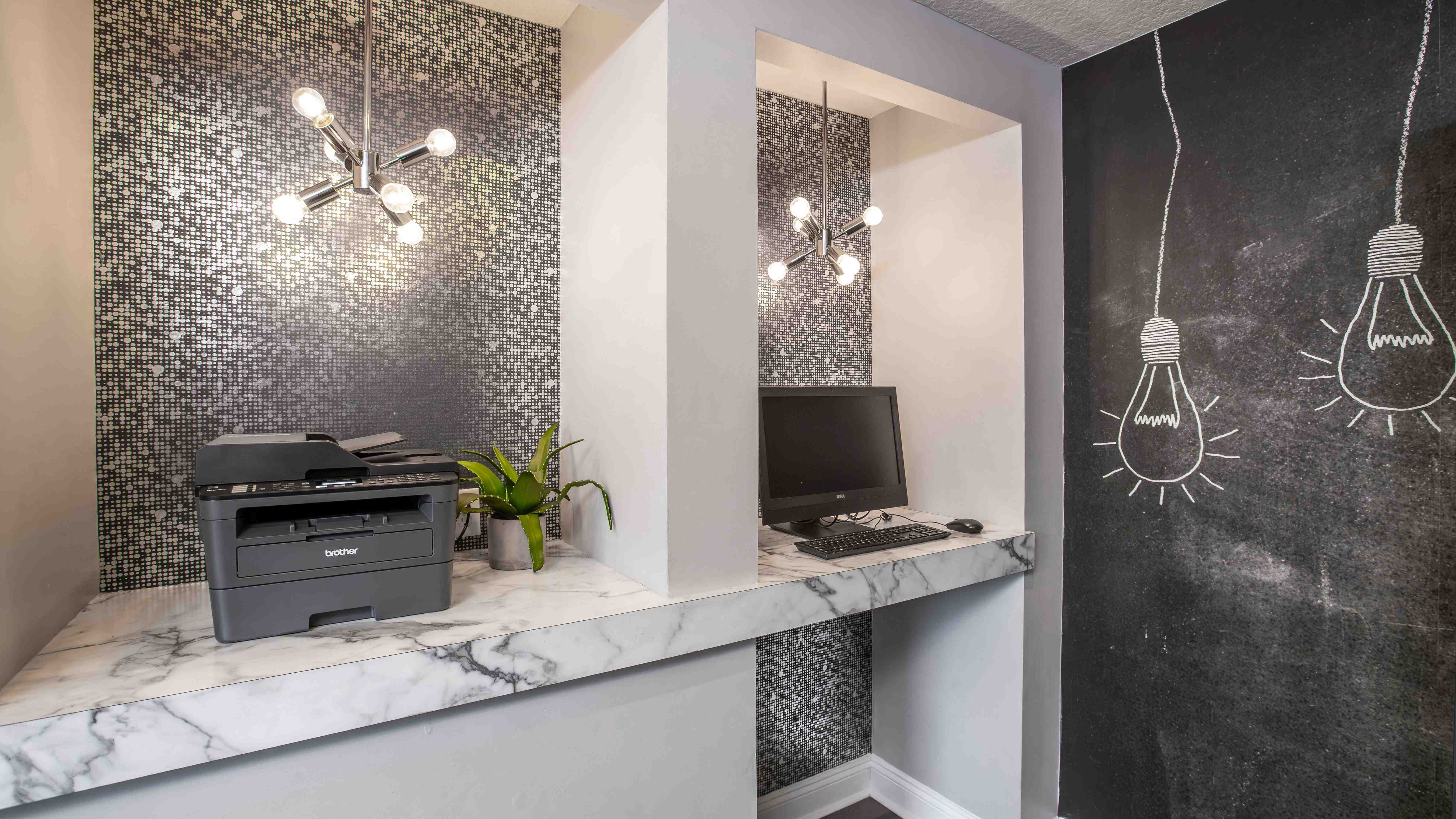 Whether you're printing documents or checking emails, the fully equipped business center at Harper Grand Apartments supports your remote work needs in style.