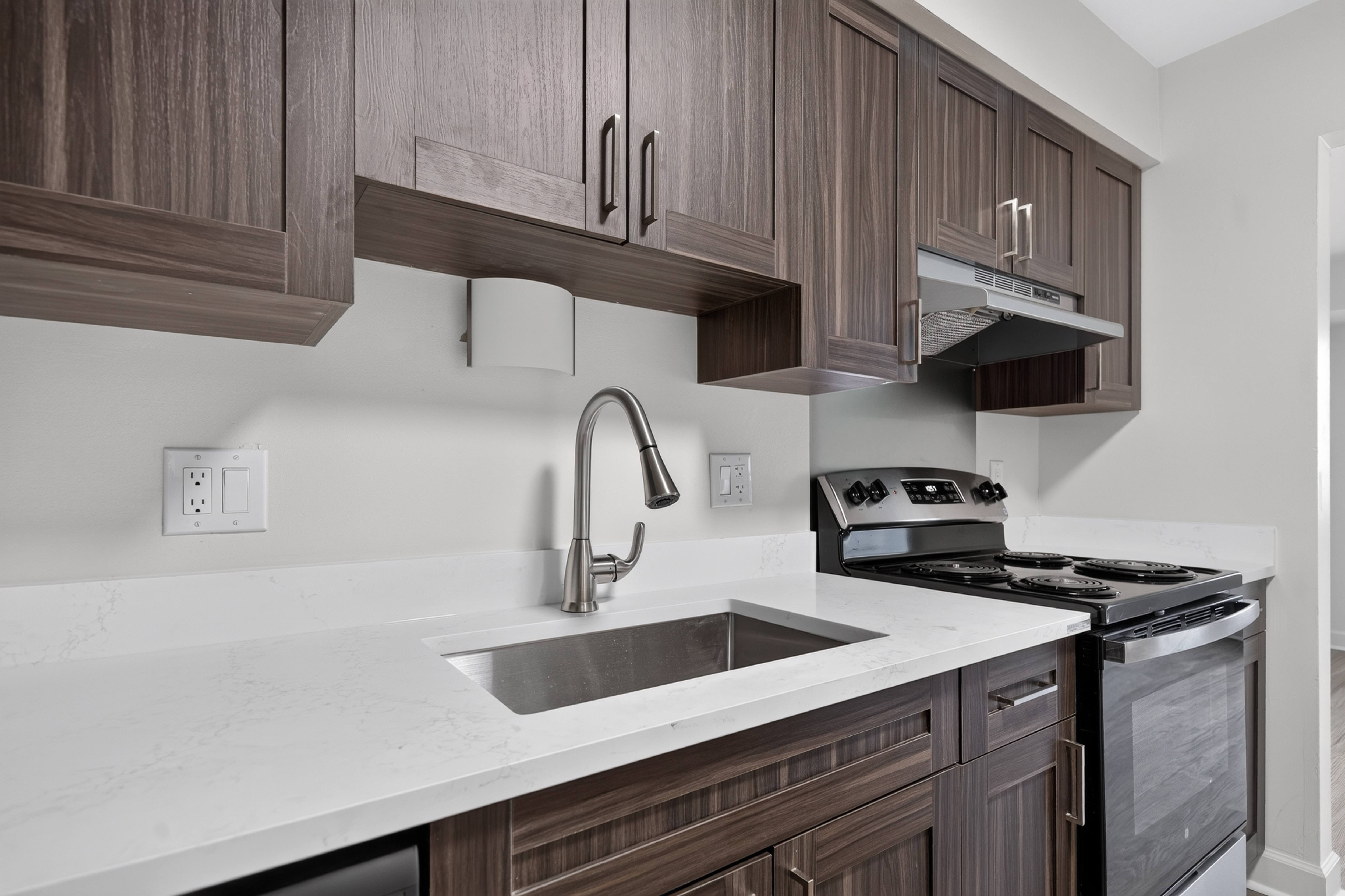 Modern kitchen with stainless steel appliances at Franklin River Apartments in Southfield, MI.