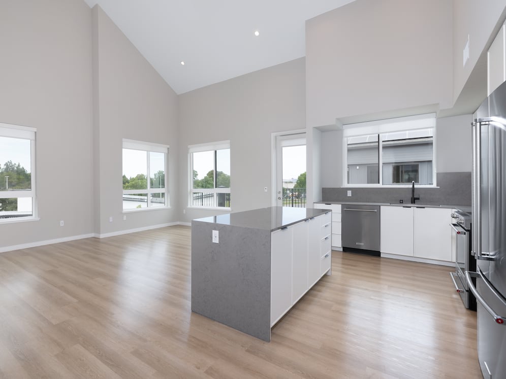 Signature Collection II Apartment kitchen, living, and dining areas with hard-surface vinyl plank flooring