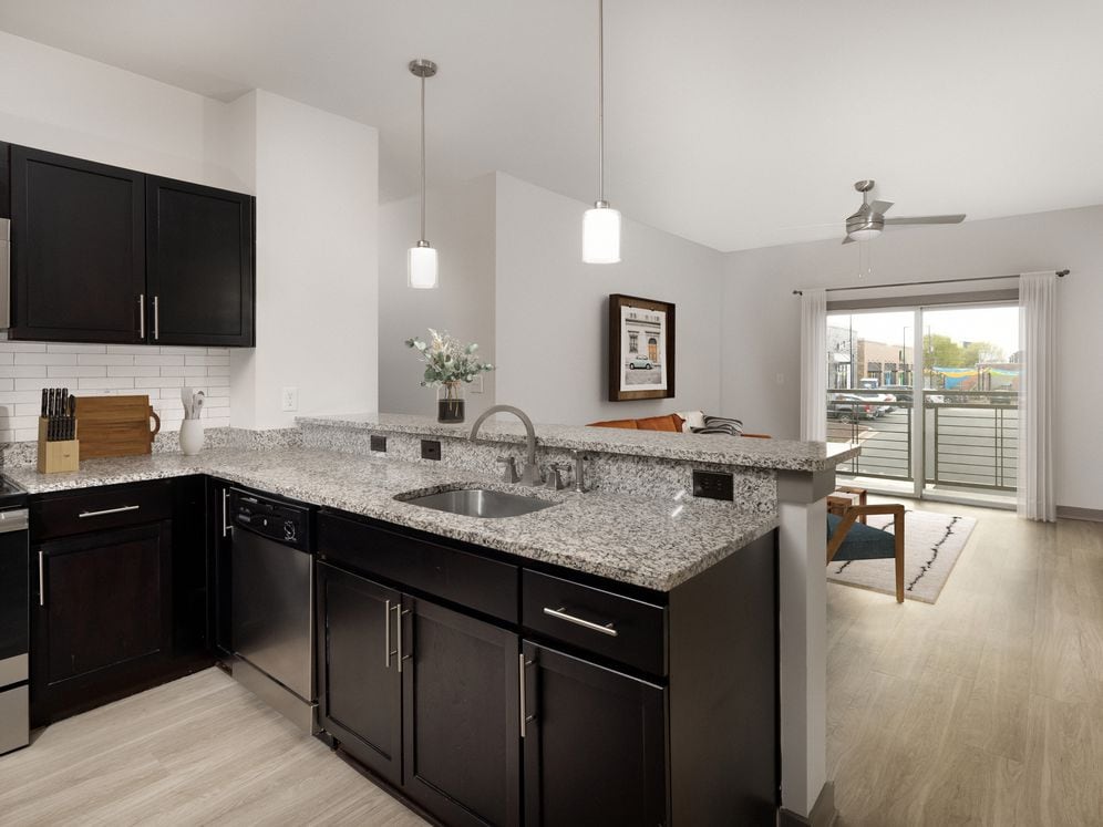 Renovated Package II Kitchen, living and dining area with hard surface flooring throughout and pendant lighting