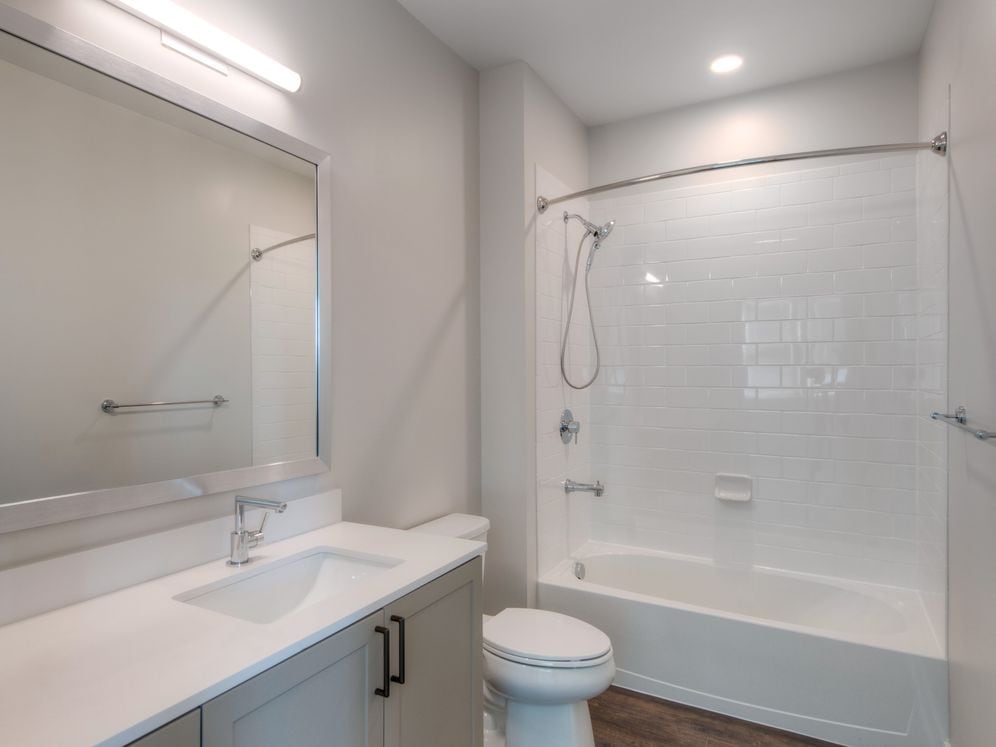 Scheme 2 bath with quartz countertop, hard surface flooring and modern fixtures