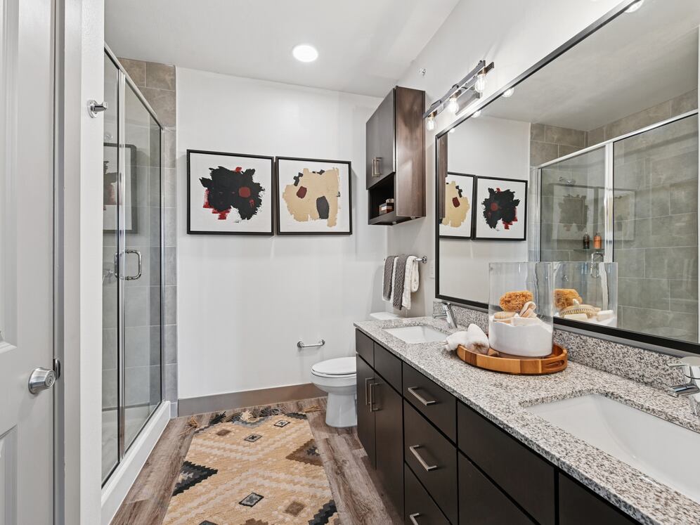 Bath with espresso cabinetry, speckled granite countertops, and hard surface flooring