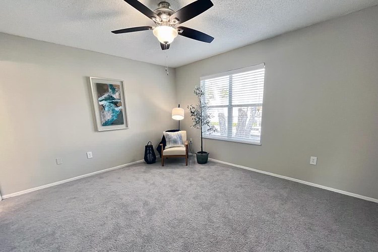 Spacious master bedrooms featuring plush carpeting, a ceiling fan, and an en suite.
