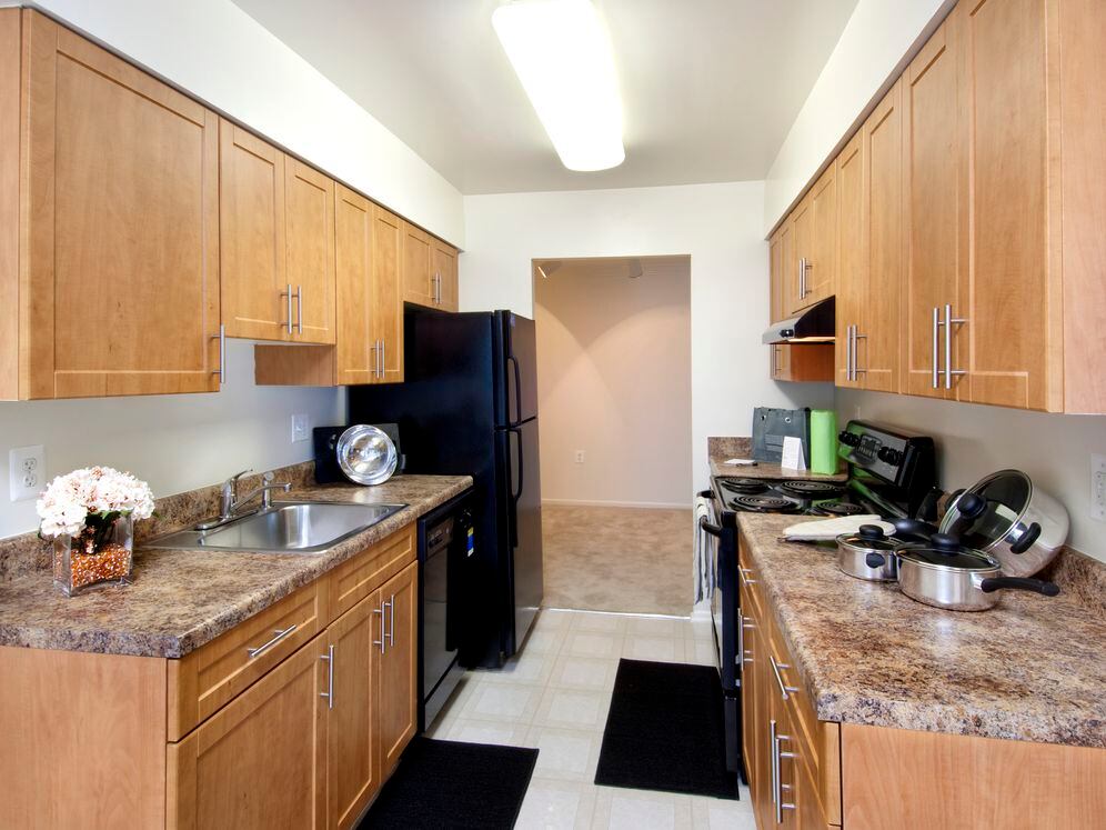 Classic Package kitchen featuring black appliances, oak cabinetry, brown laminate countertops, and tile flooring
