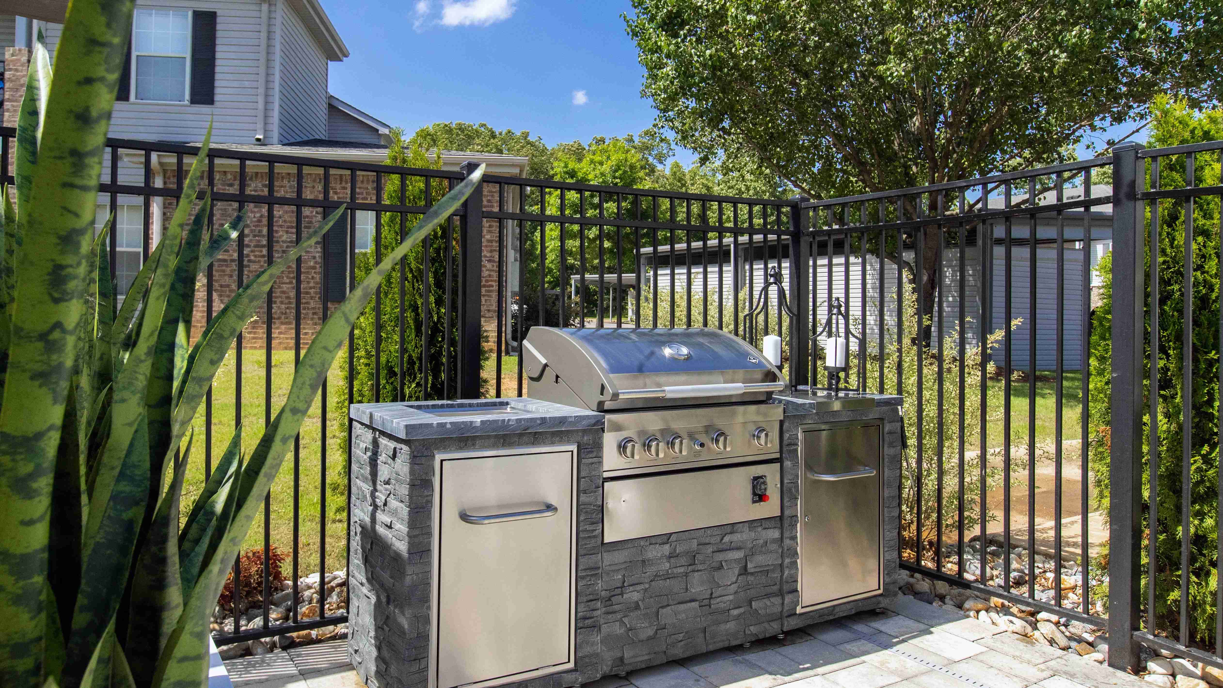 Savor the joy of at-home cookouts with our outdoor kitchen featuring a convenient gas grill with extra counterspace for memorable poolside barbecue experiences.