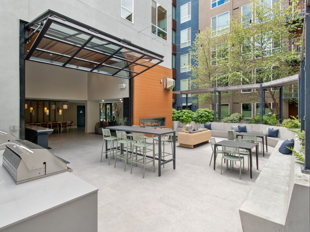 Outside resident lounge with common area seating and fireplace