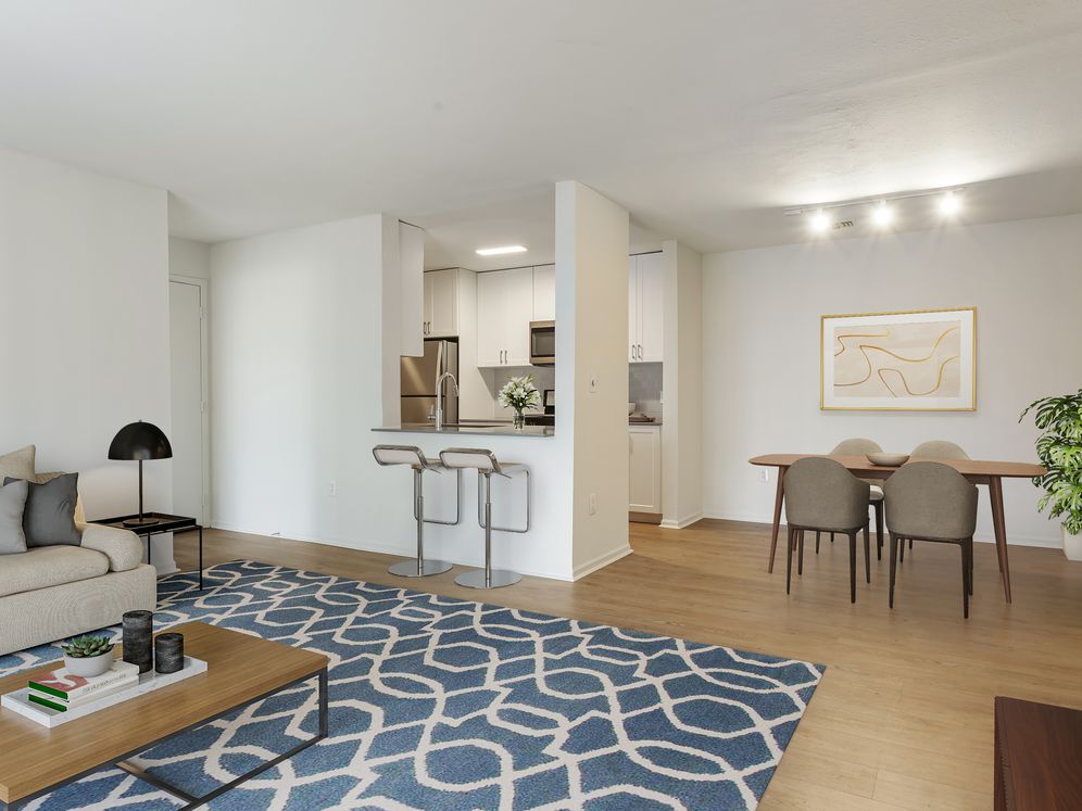 Renovated Package I kitchen, living, and dining areas with hard surface flooring