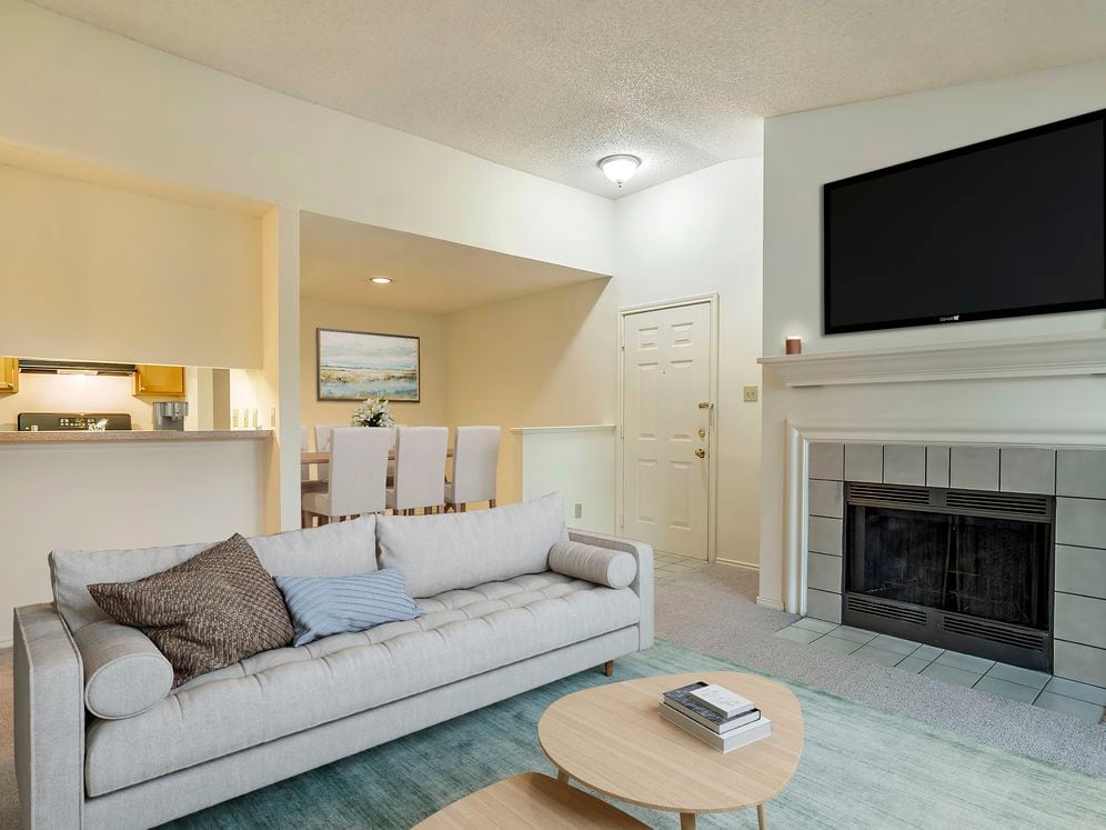 Classic Package kitchen, living and dining area with carpeted floor and fireplace