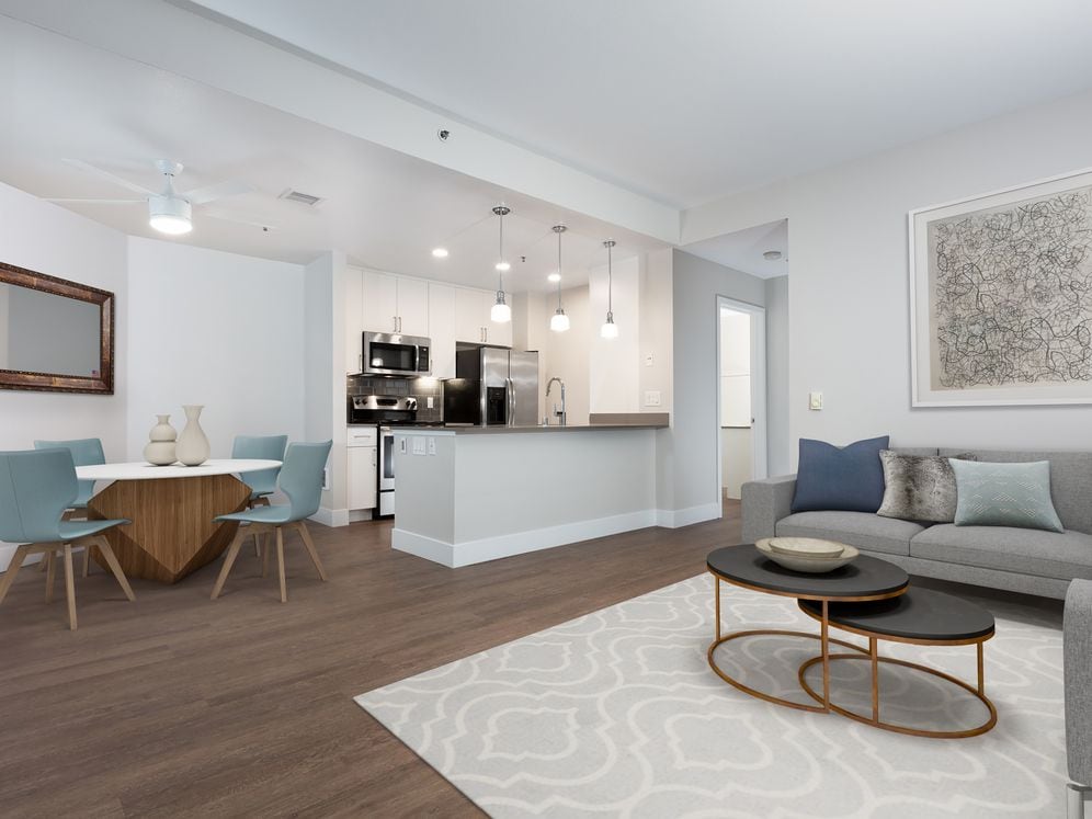 Renovated Phase I kitchen with quartz countertops, tile backsplash, and stainless steel appliances