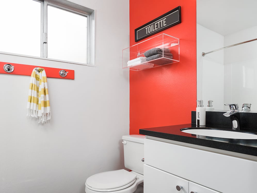 Classic Package II bath with black laminate countertops, white cabinetry, and hard surface flooring