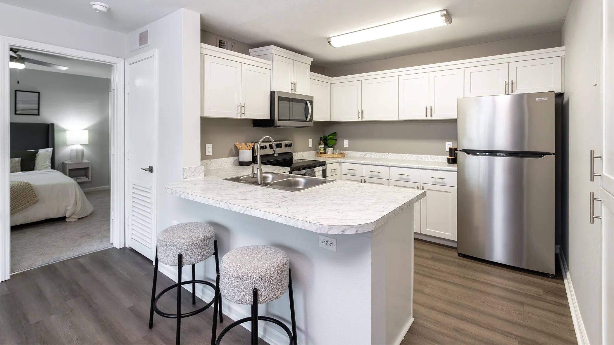 Indulge open living in this stunning kitchen oasis boasting ample cabinetry and a versatile breakfast bar overlooking the living area for the ultimate in convenience and style. 