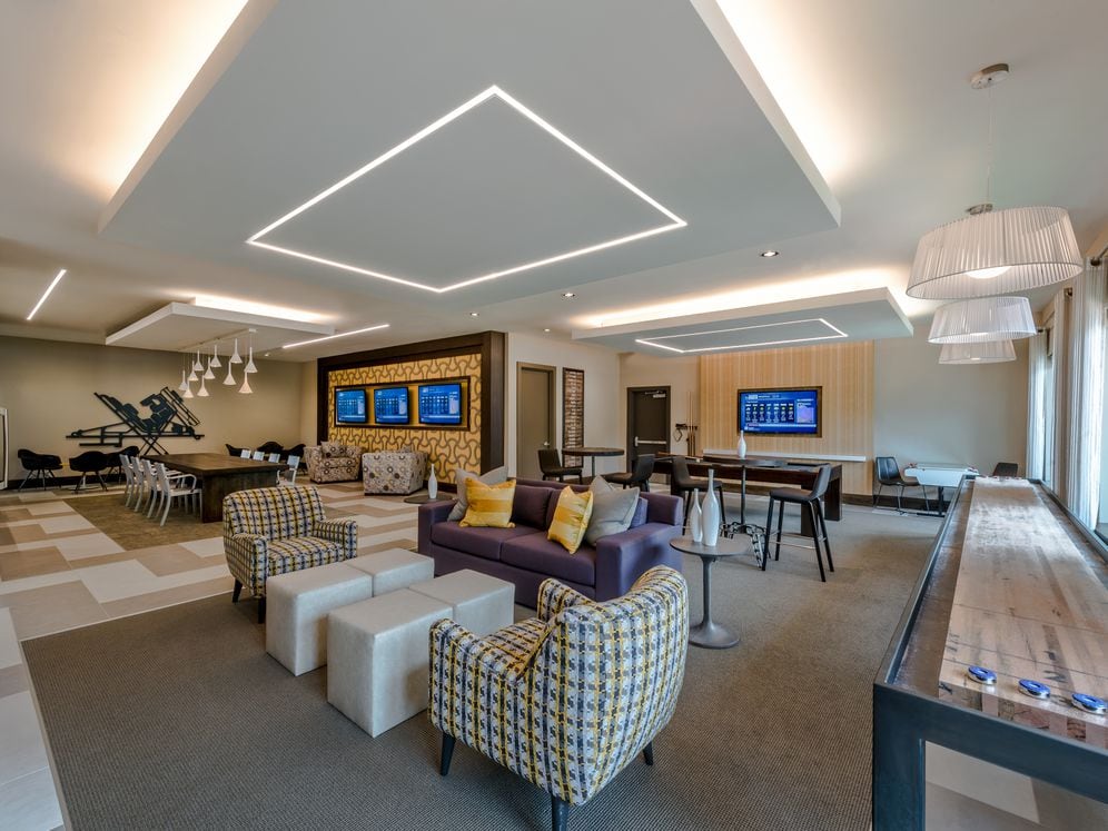 Resident lounge with shuffleboard, flat screen televisions and seating