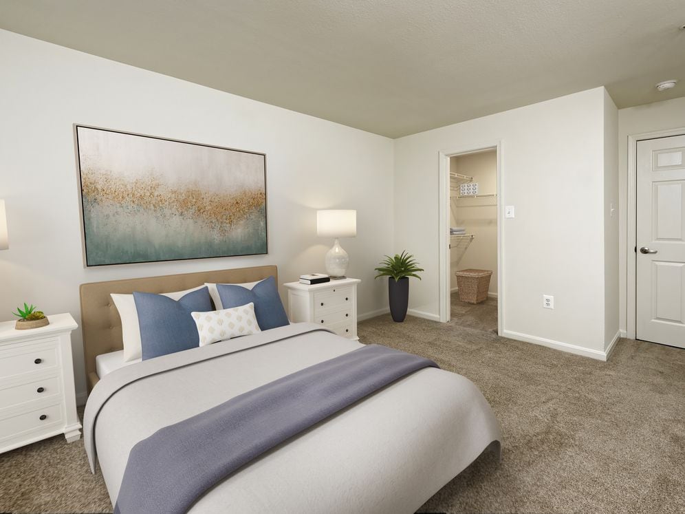 Bedroom with carpeted flooring and walk in closet