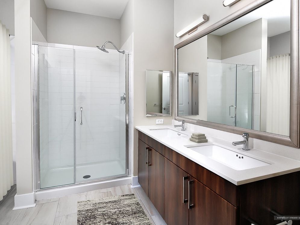 Signature Collection bath with oak cabinetry, white quartz countertops, and hard surface flooring