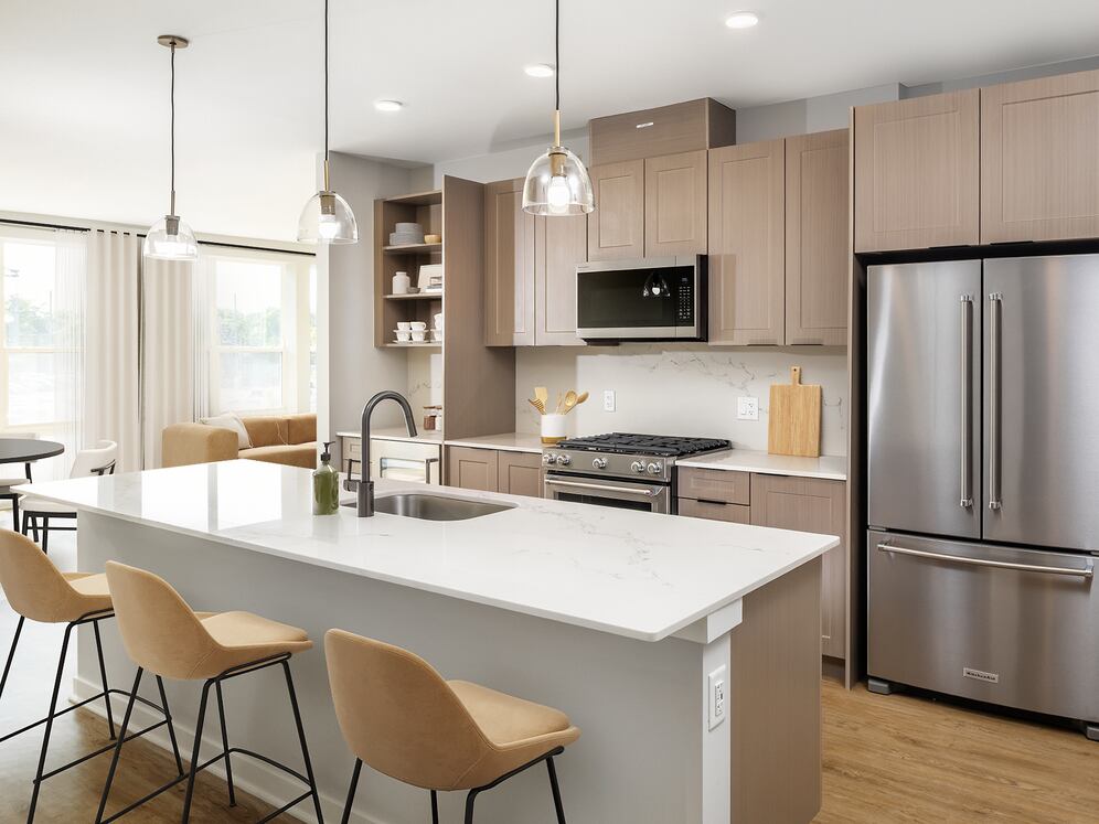 Signature Collection Kitchen with oak shaker cabinetry, marbled white quartz countertop, and upgraded stainless steel appliances