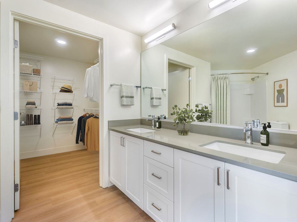 Renovated Package I bath with white cabinetry, grey quartz countertops and hard surface flooring