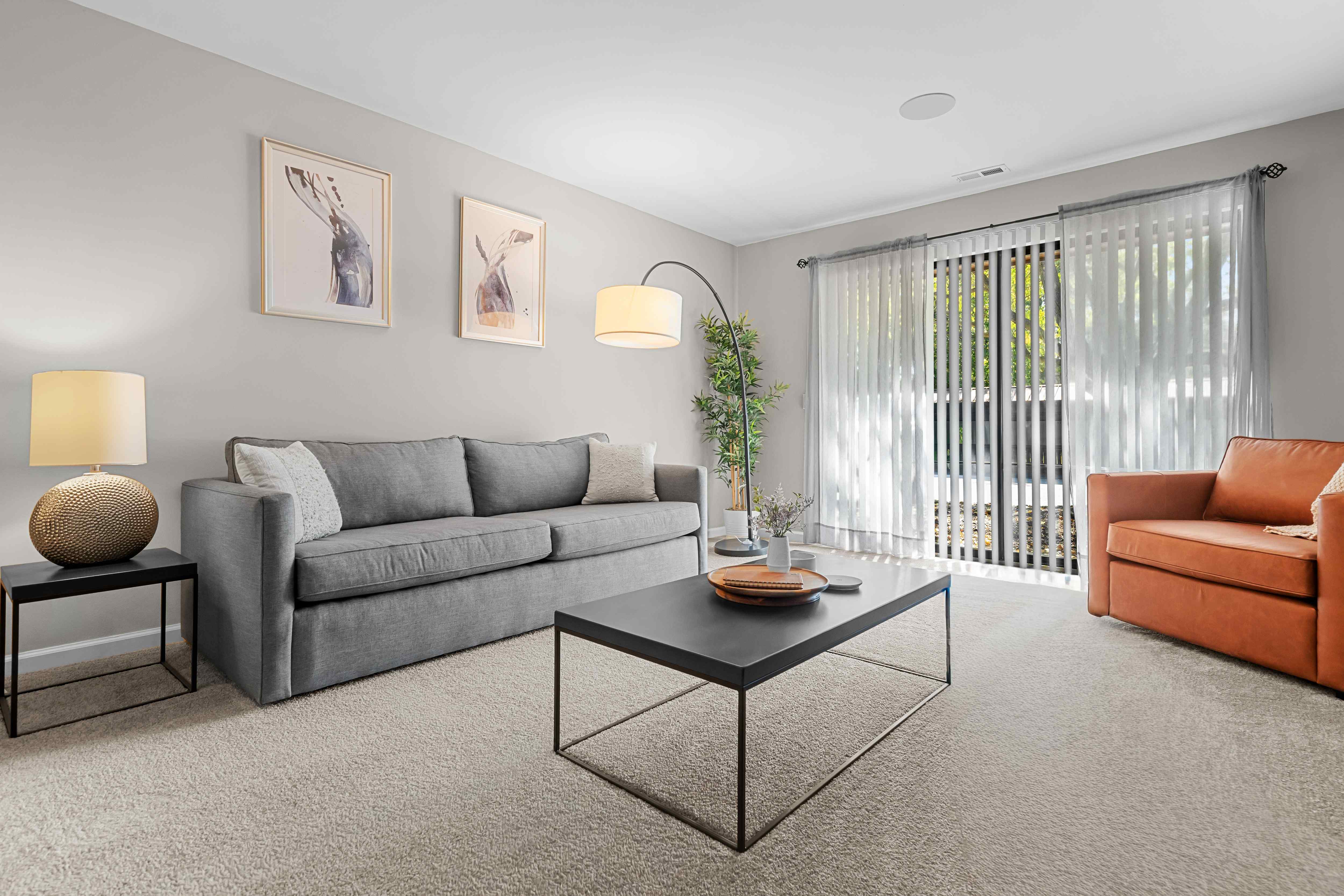Spacious Living Room with Sliding Glass Door at Lakeside Village Apartments Clinton Township MI